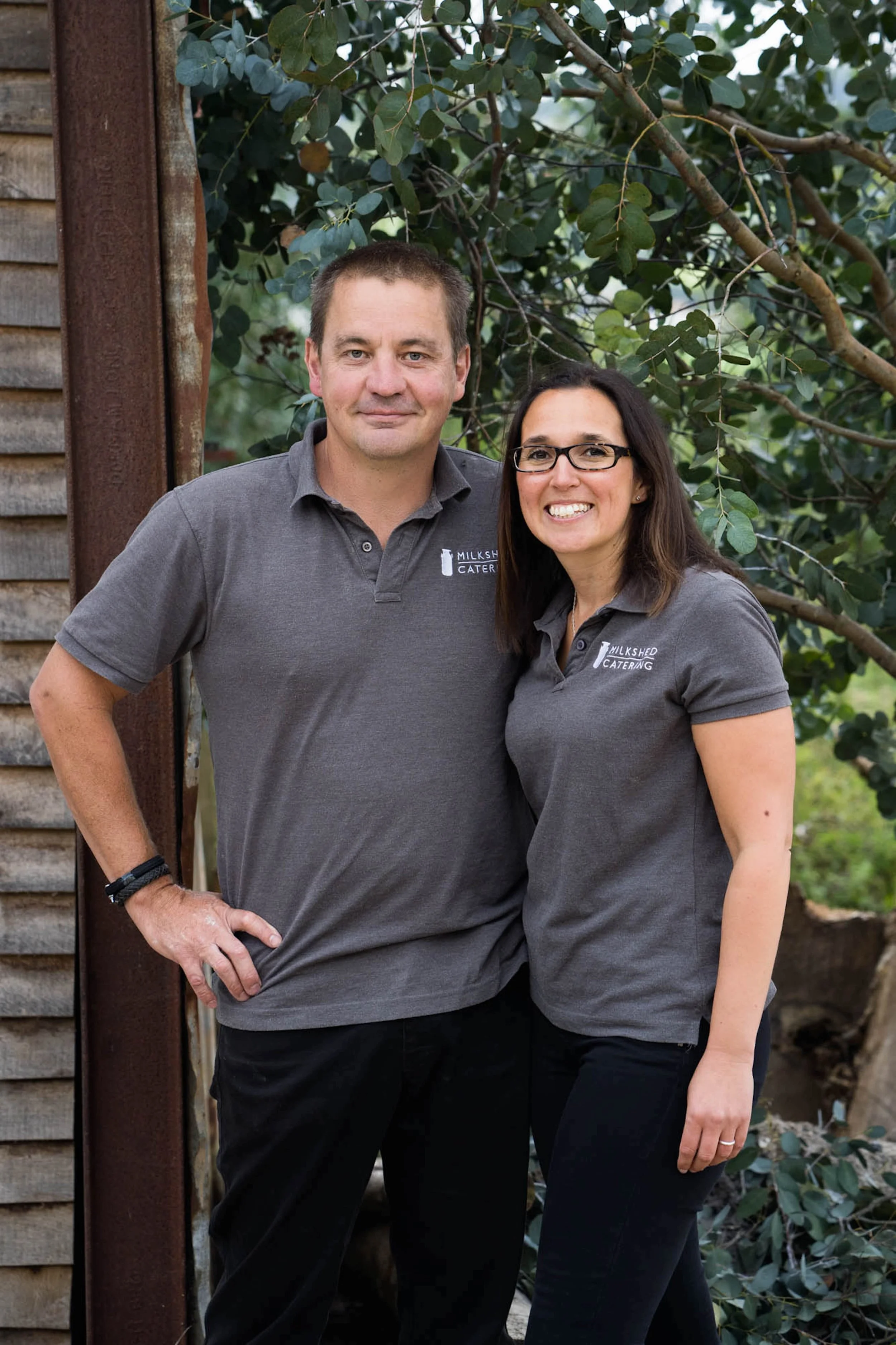 Milkshed owners, Katie and Mark, smiling and proud of the wedding catering business in Devon.