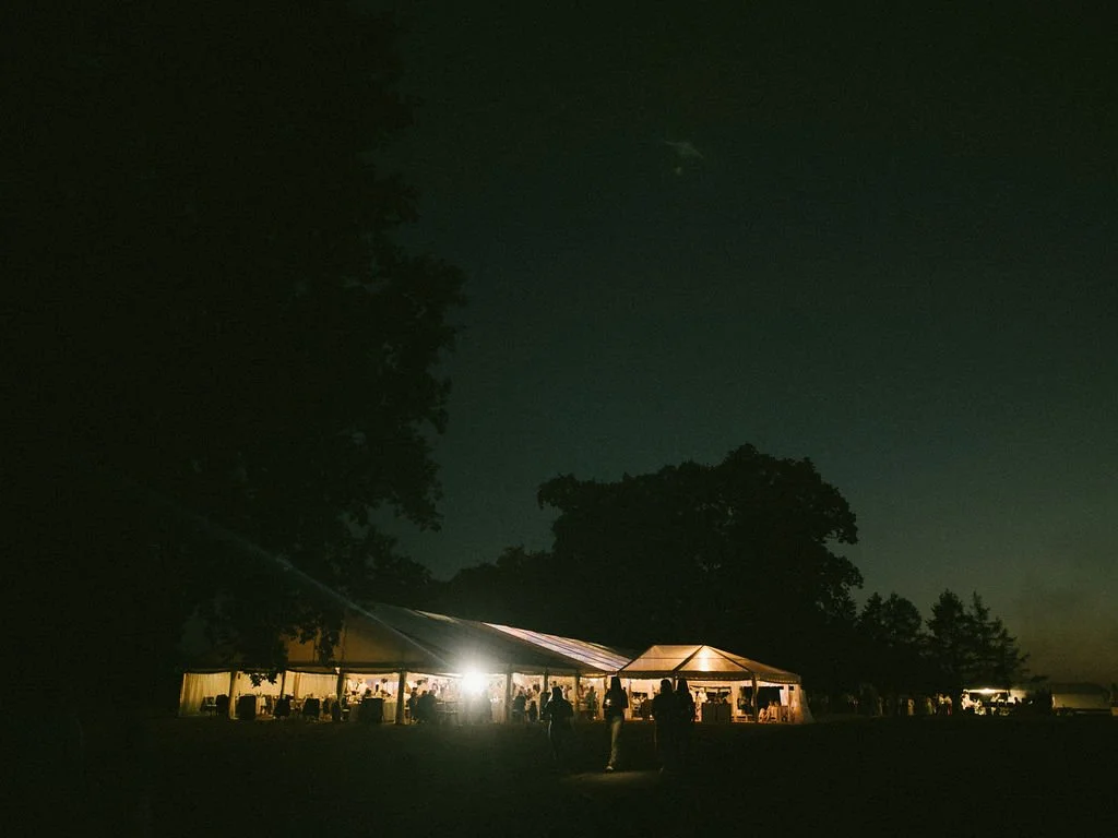 Nighttime wedding marquee for an outdoor gathering at Earnshill House in Somerset.