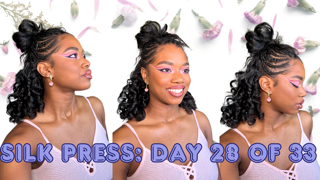 A woman with curly hair styled in an intricate updo with braids, wearing pink makeup and earrings, posing against a background with falling flowers and petals, with text overlay reading 'Silk Press: Day 28 of 33'.