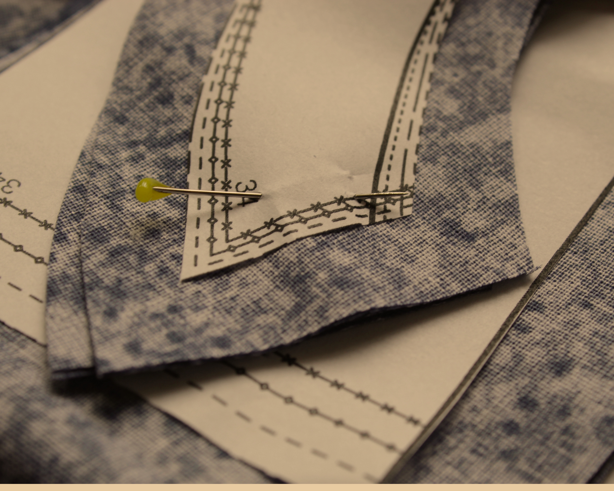Fabric with pattern and pins, used for tailoring.