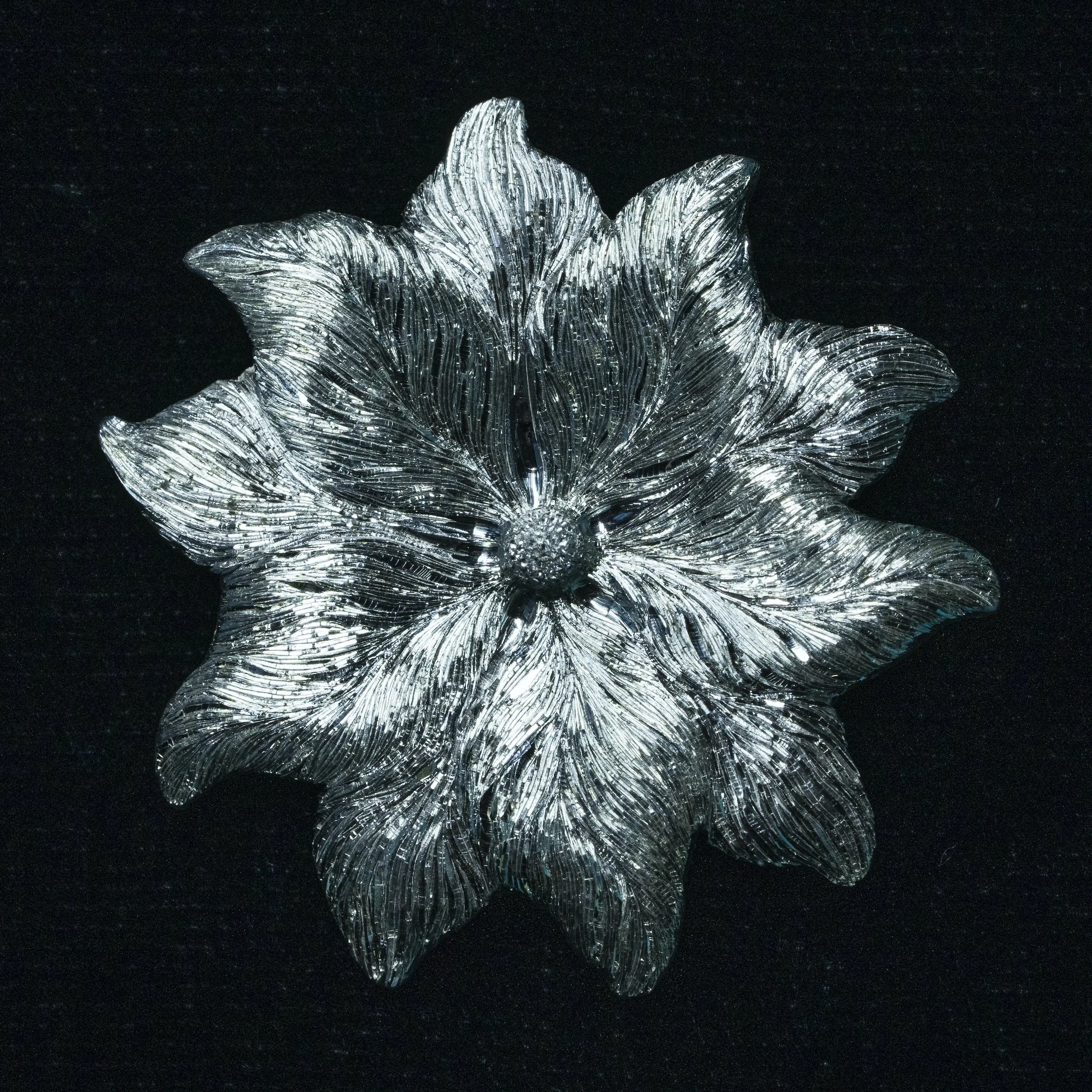 OLAFSSON, ANNA. 5. Silver_Columbine_flower_carving_and_hand_engravingpendant_brooch_23mm_diameter_2025_Photocredit_KyleHowie.jpeg