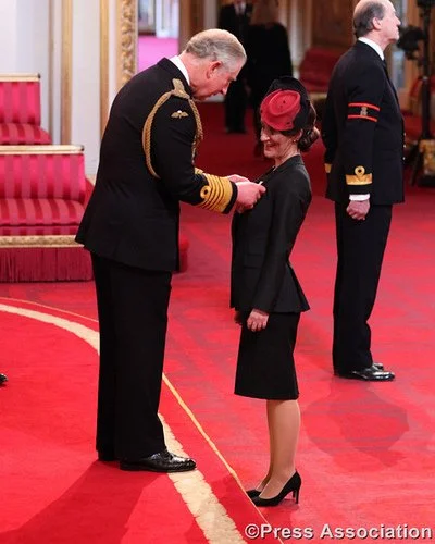 King Charles III awards Sarah Hearn the OBE at Buckingham Palace in 2013.