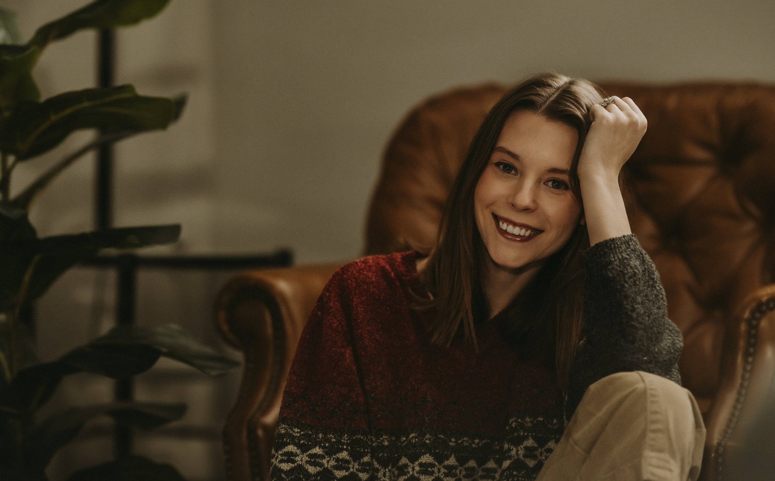 Filmy, lifestyle headshot of photographer in a cozy sweater