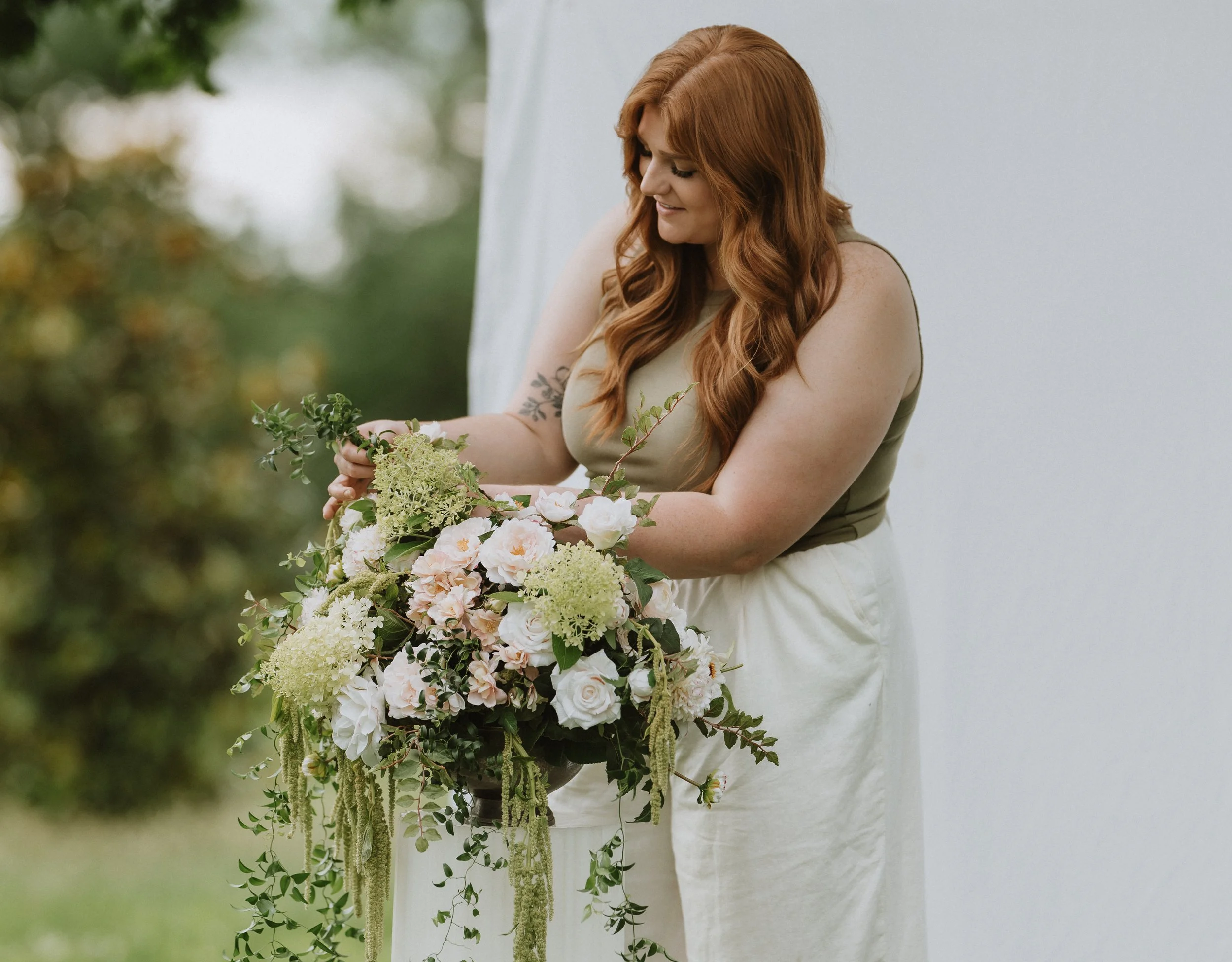 Florist arranging a dreamy bouquet in an outdoor setting.