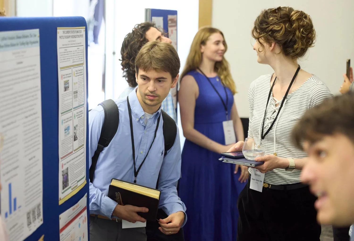 Researchers discussing a poster at an ERA event.