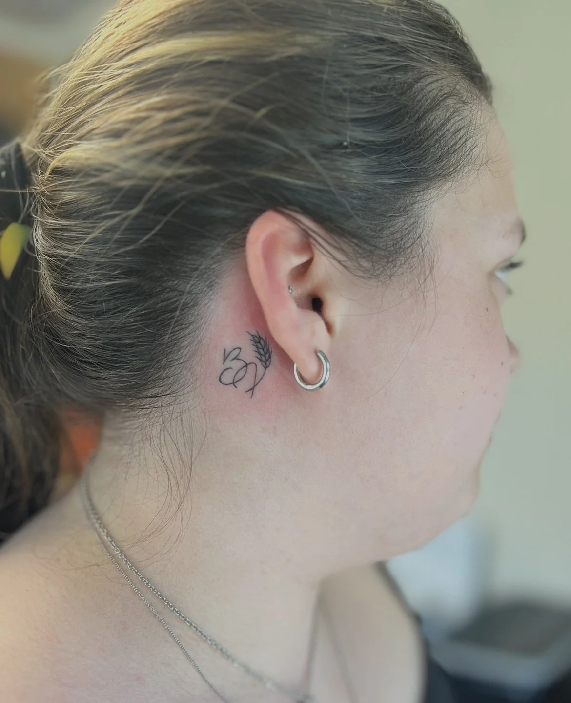 small initial tattoo behind ear