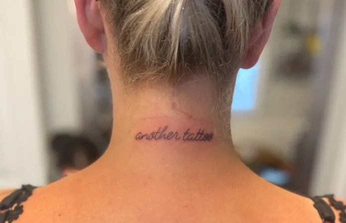Another tattoo writing on neck