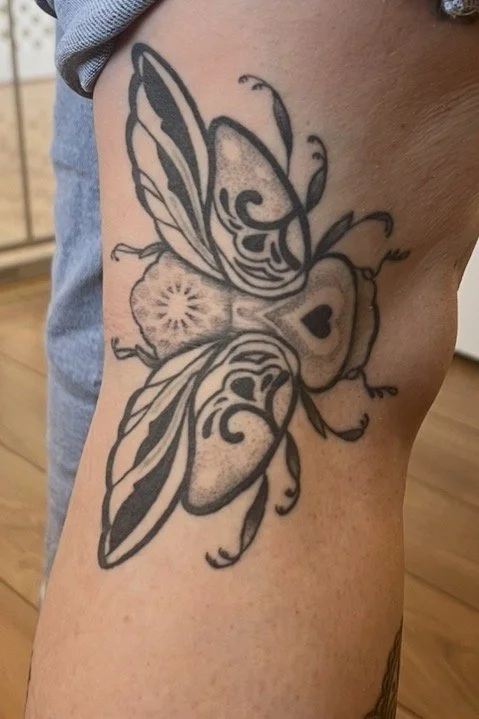 heal tattoo of a beetle side knee tattoo
