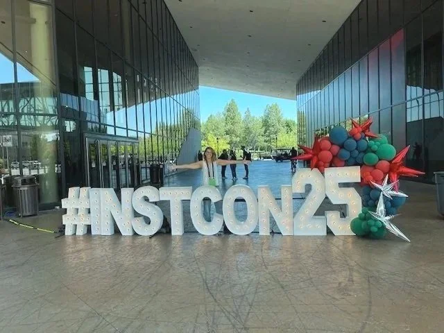 Angie in front of the Instructurecon25 sign