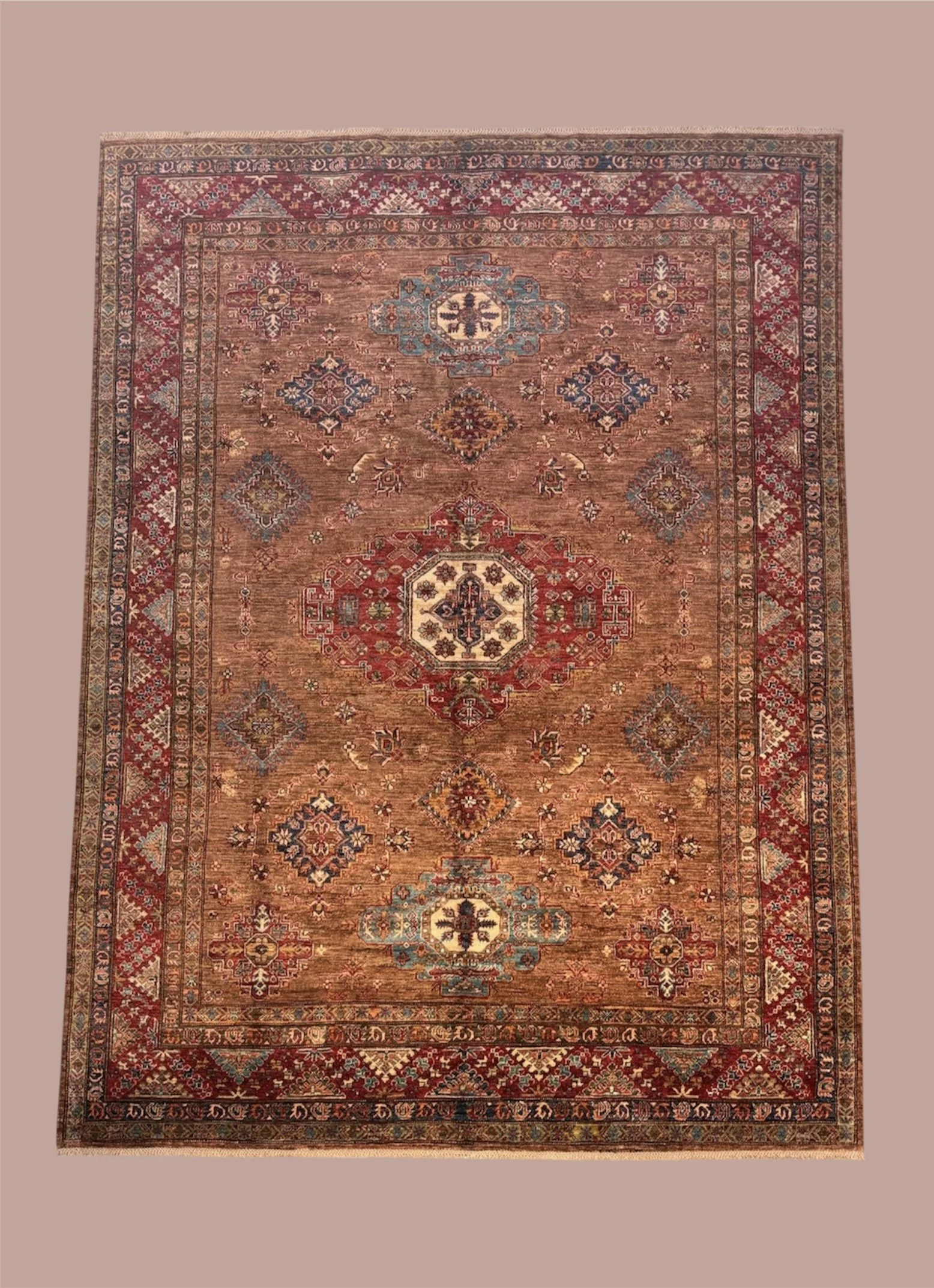 Traditional Persian-style rug with intricate geometric and floral patterns in shades of red, blue, beige, and gold, displayed on a neutral background.