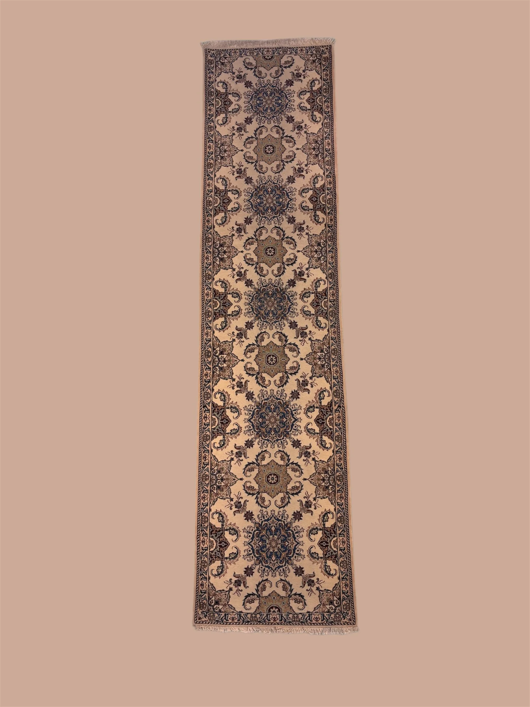 Long, narrow Persian-style rug with intricate floral and geometric patterns in shades of beige, blue, and brown.