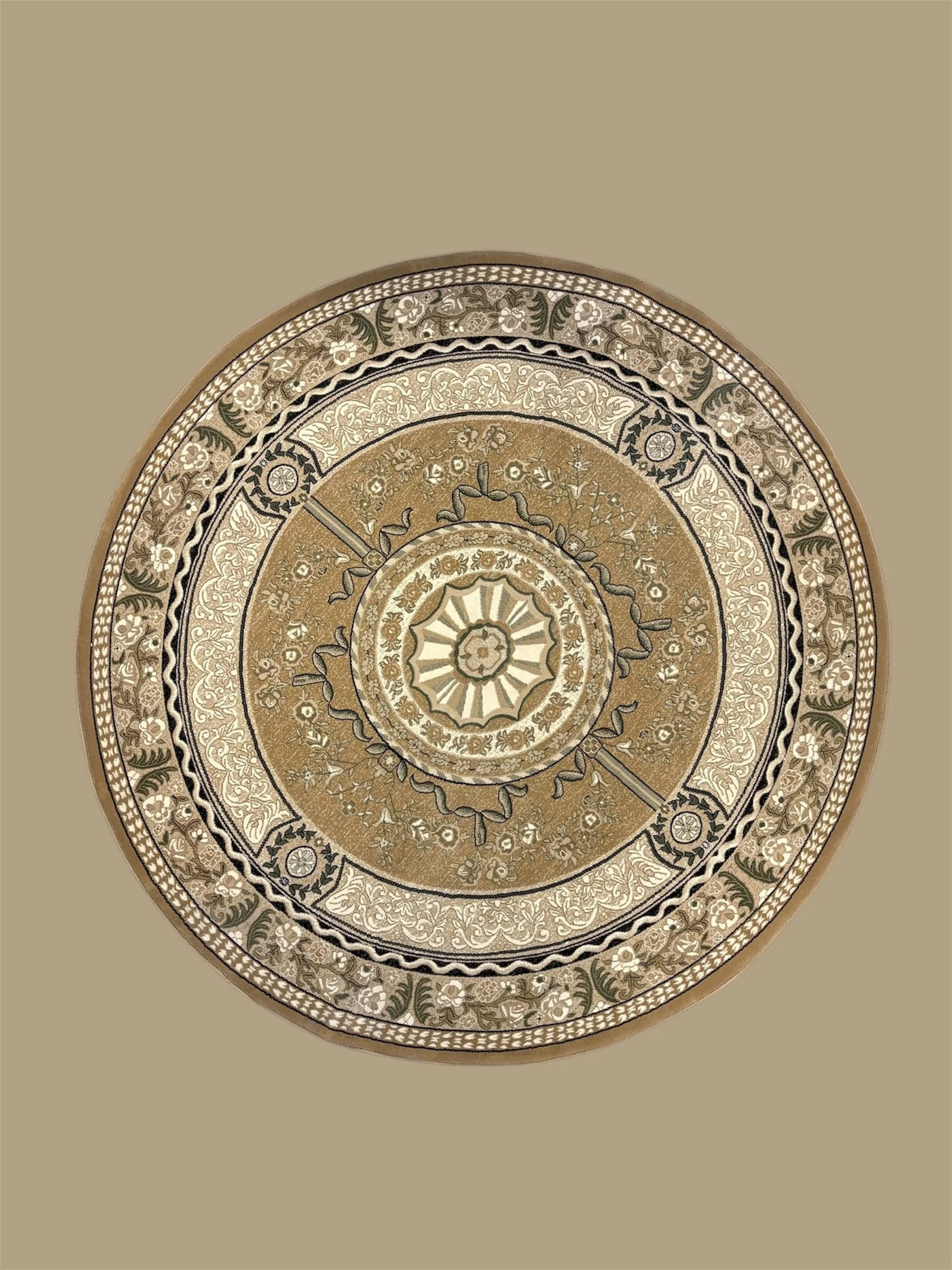 A detailed, decorative round rug with intricate floral and geometric patterns in shades of gold, beige, and black, placed on a plain beige background.