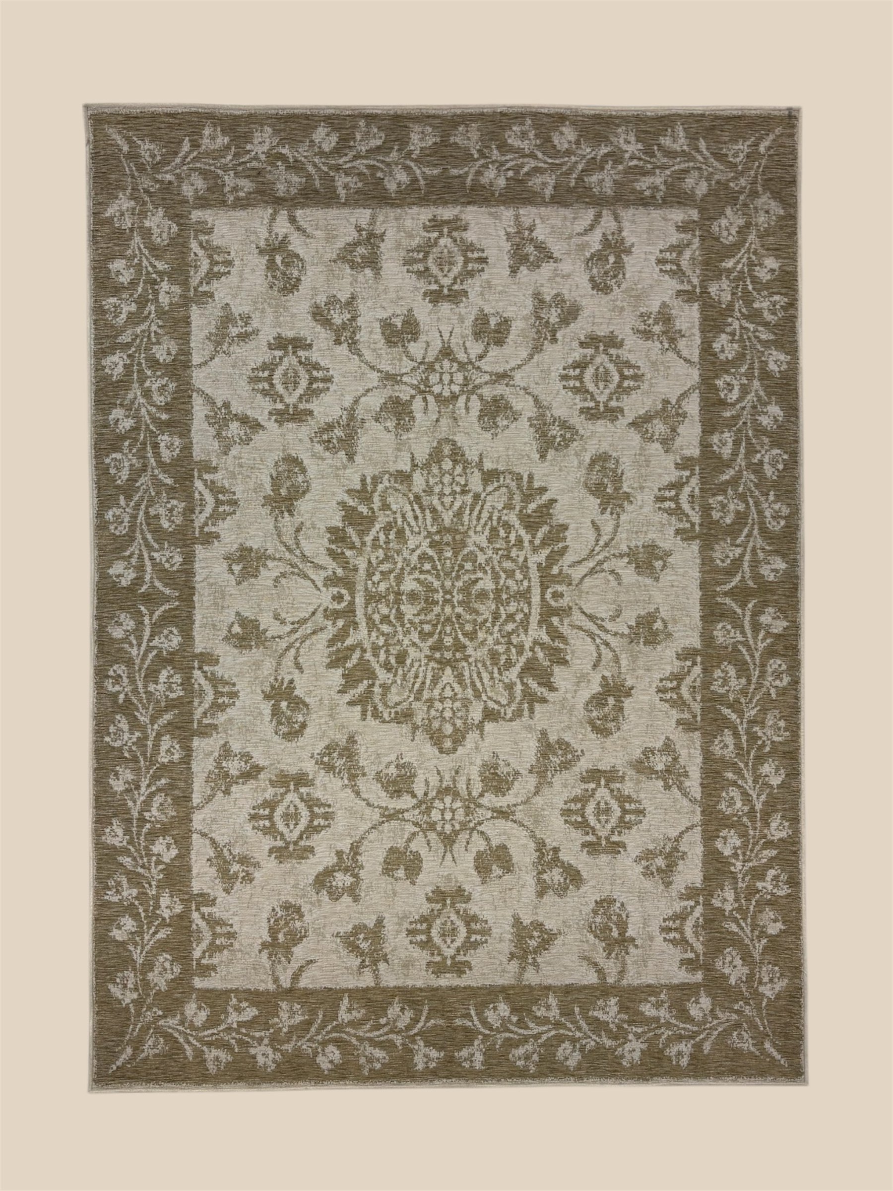A beige and brown patterned area rug with floral and geometric motifs.