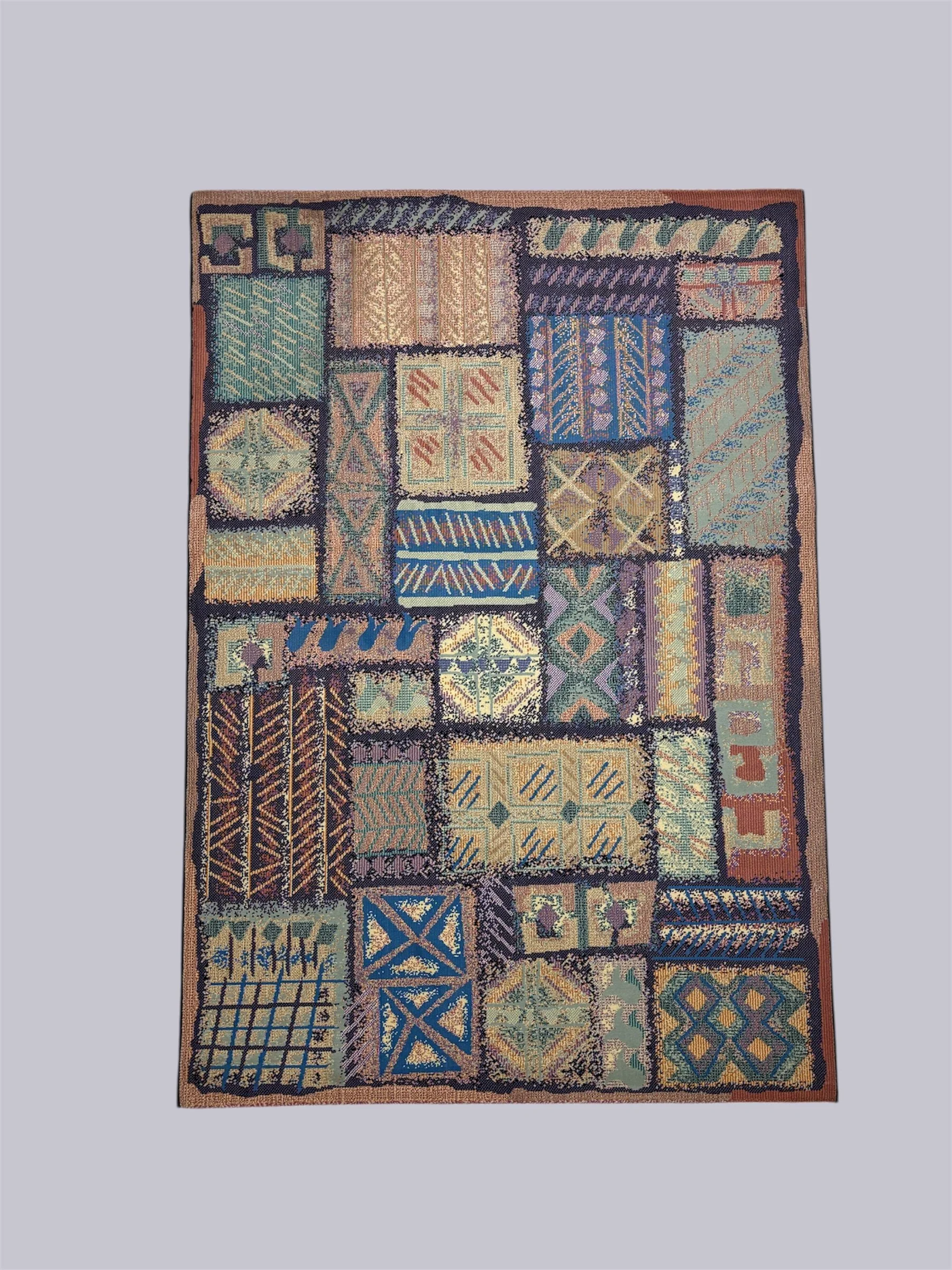 Colorful patchwork rug with various geometric patterns and motifs in shades of blue, green, yellow, purple, and beige.