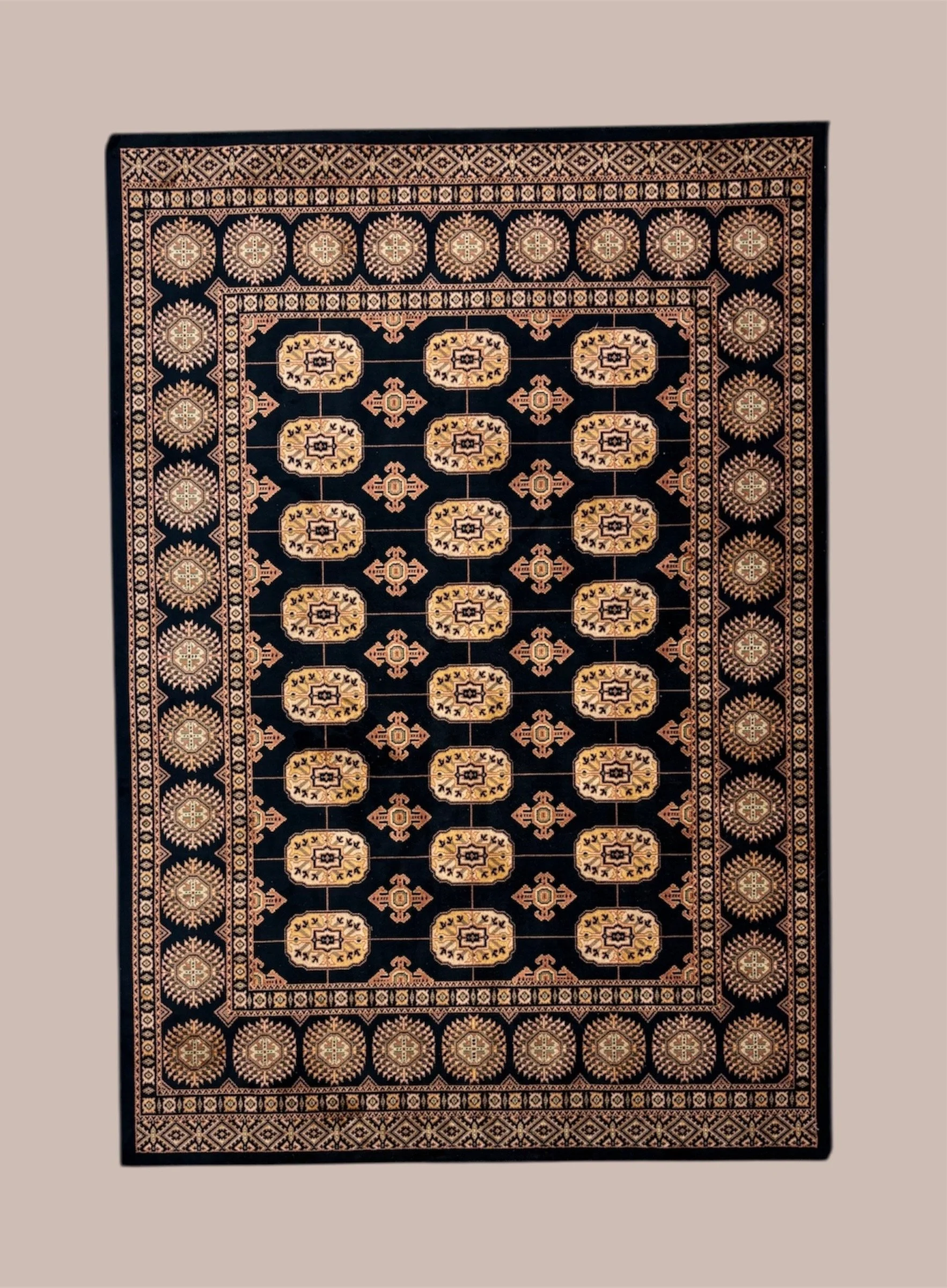 A traditional Persian-style rug featuring a black background with intricate gold and beige geometric patterns and borders.