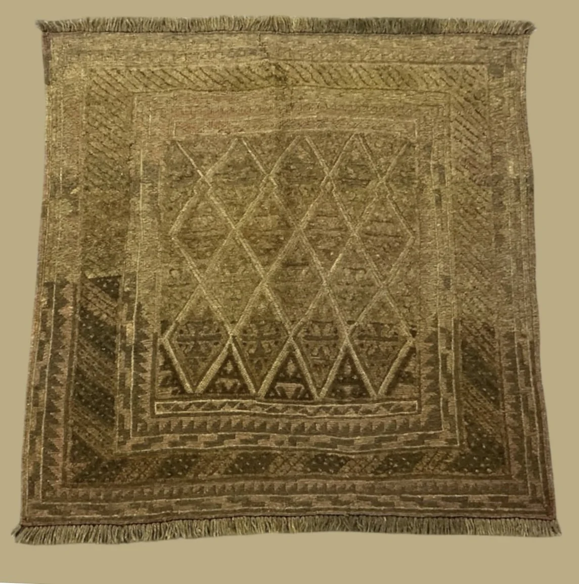 A traditional woven rug with geometric patterns in shades of brown and beige, featuring a central diamond design surrounded by intricate border motifs.