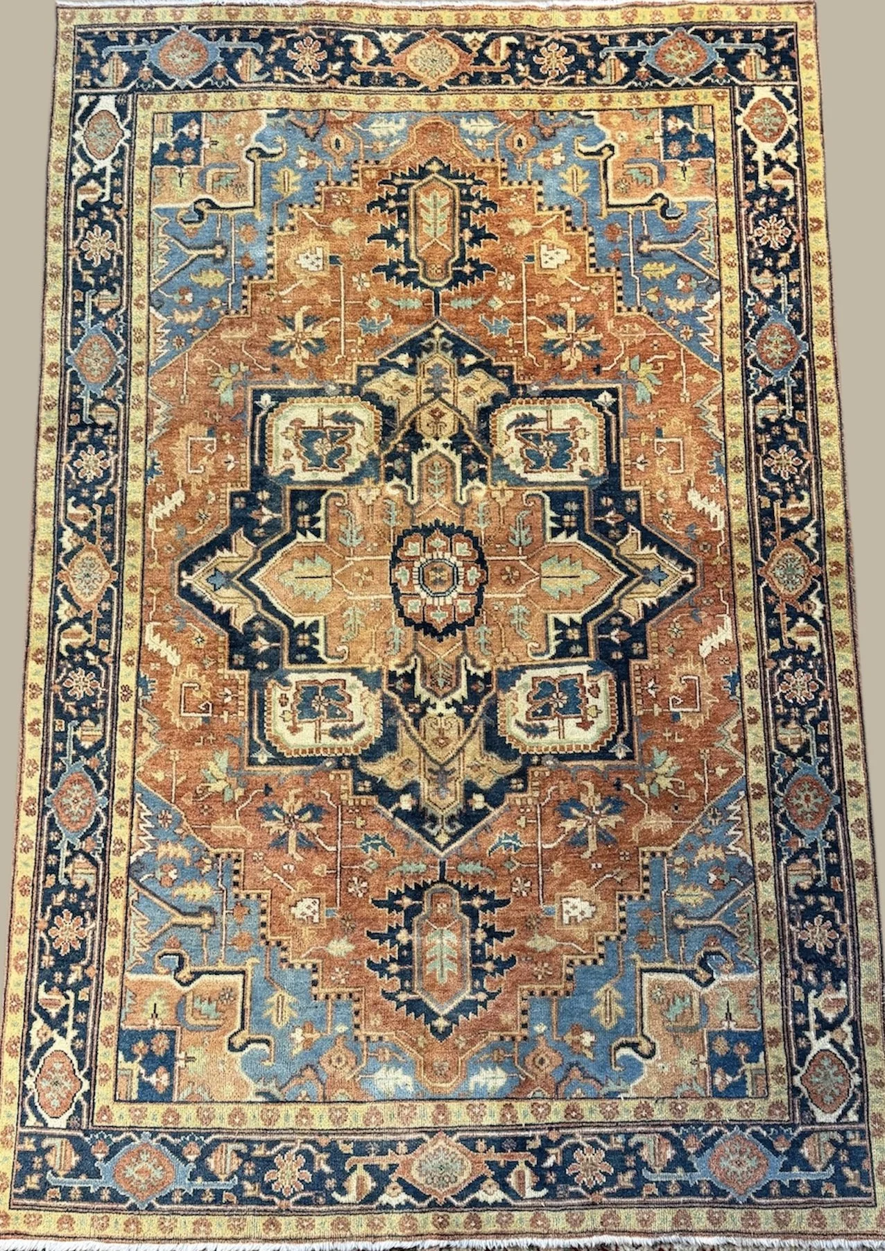 Traditional Oriental-style area rug with intricate floral and geometric patterns in shades of blue, orange, beige, and cream.