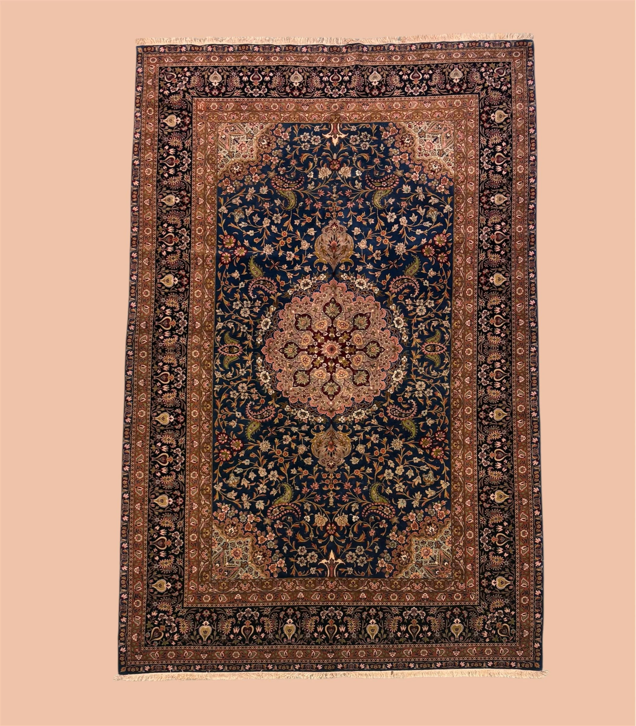 A traditional Persian-style rug with intricate floral designs on a dark navy background, framed by multiple decorative borders in shades of gold, pink, and black.