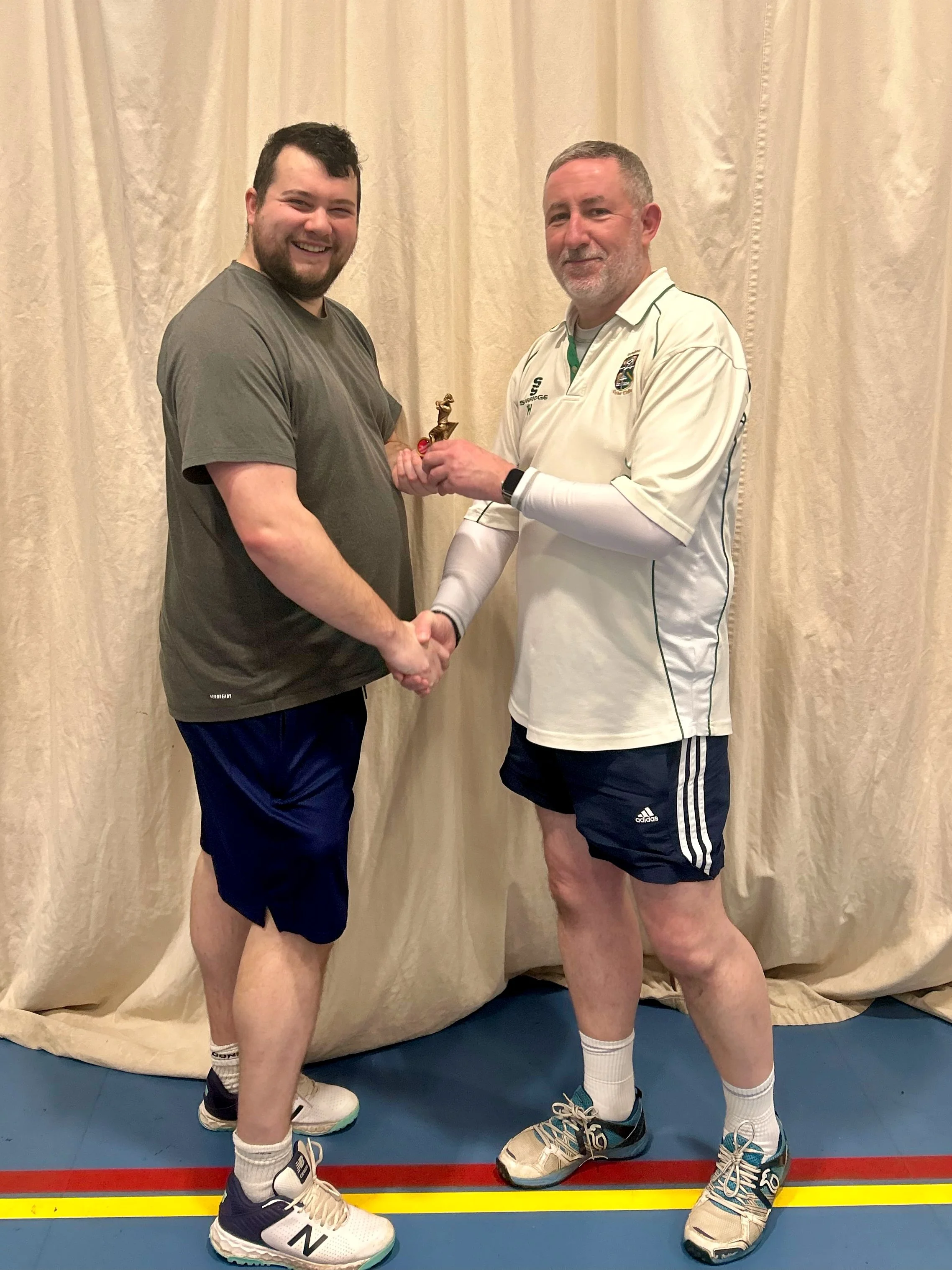 Jamie Good receives the trophy for the leading bowler in ESCA Division 6 for 2025