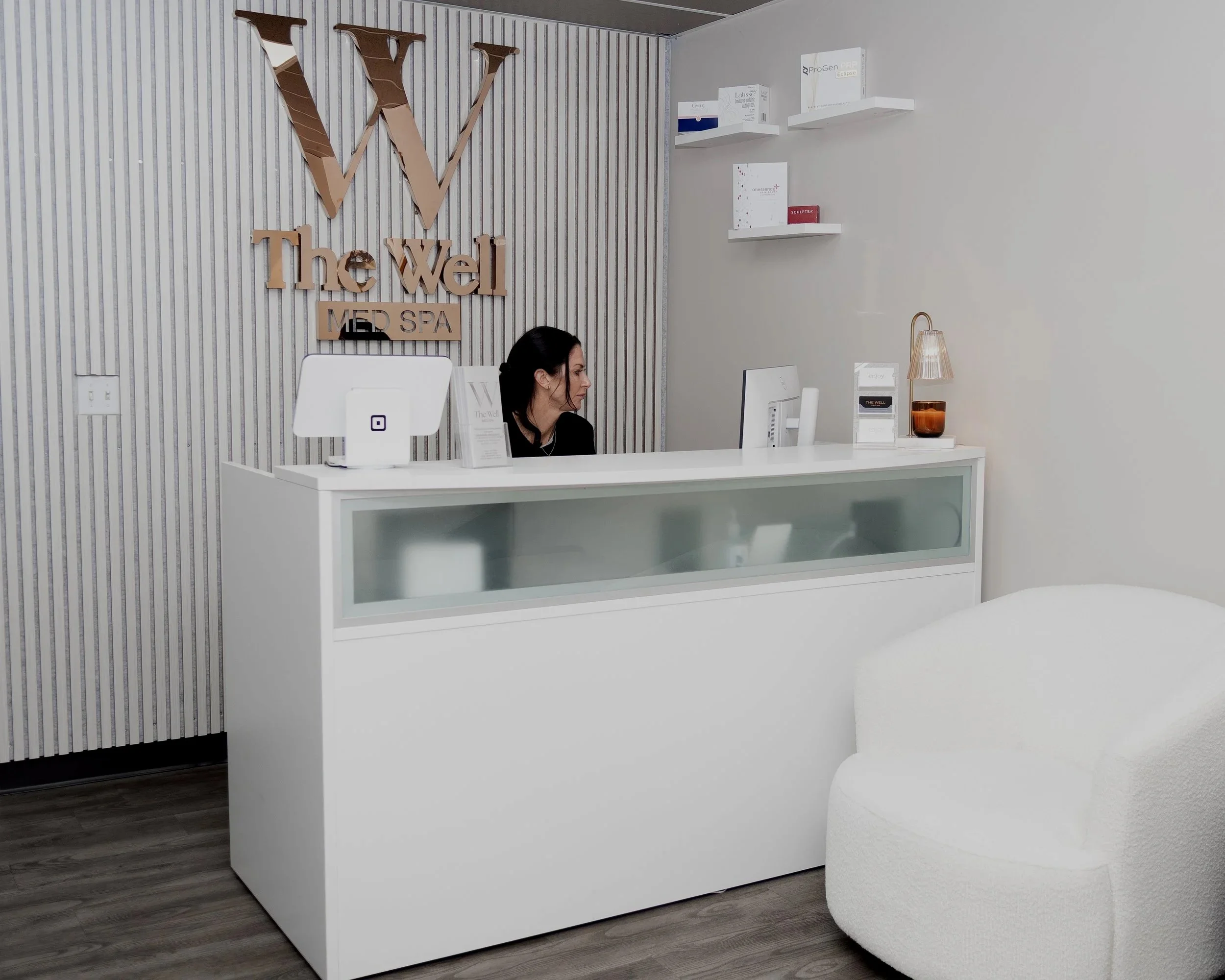 A person using a dropper to apply oil or serum onto their skin.