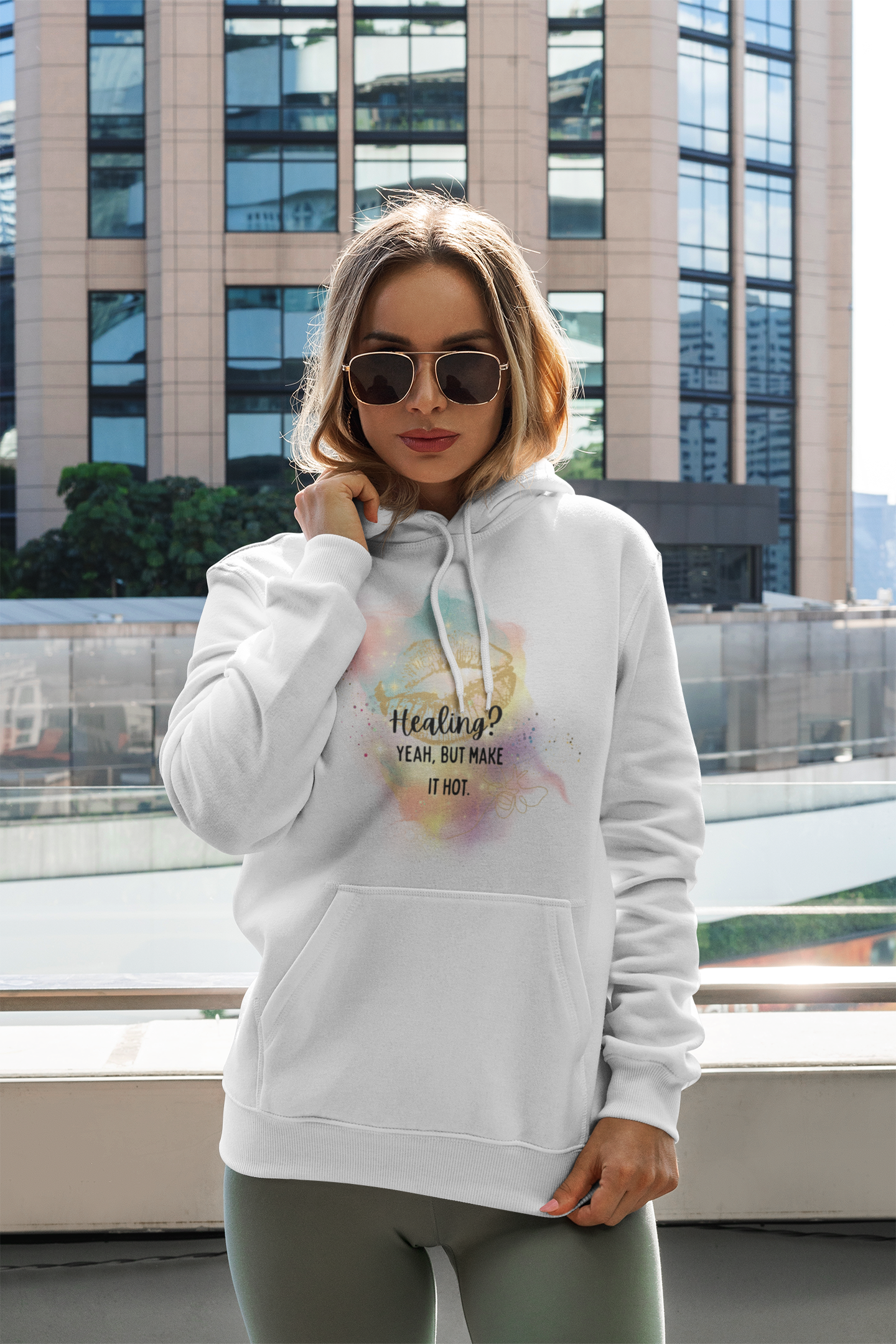 mockup-of-a-woman-with-a-pullover-hoodie-posing-by-a-tall-building-3549-el1.png