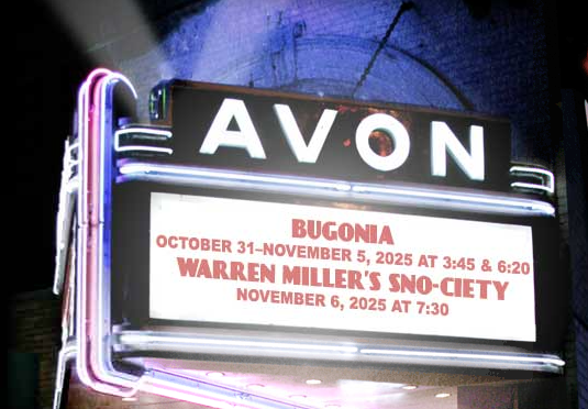Marquee sign for Avon theater displaying upcoming movies Bugonia and Warren Miller's Snow-Ciety with dates and showtimes.