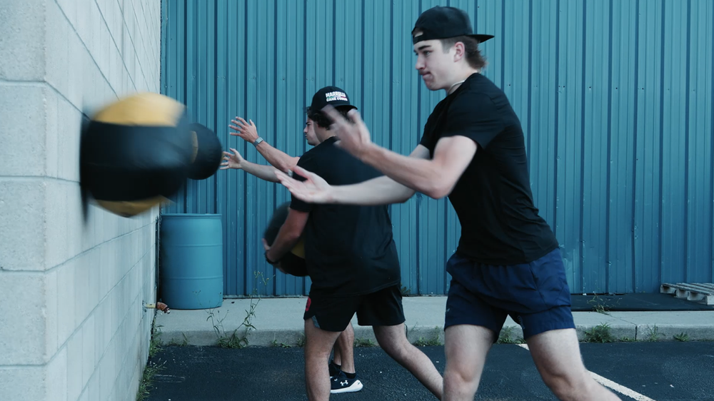 Coach guiding an athlete through a sport-specific drill