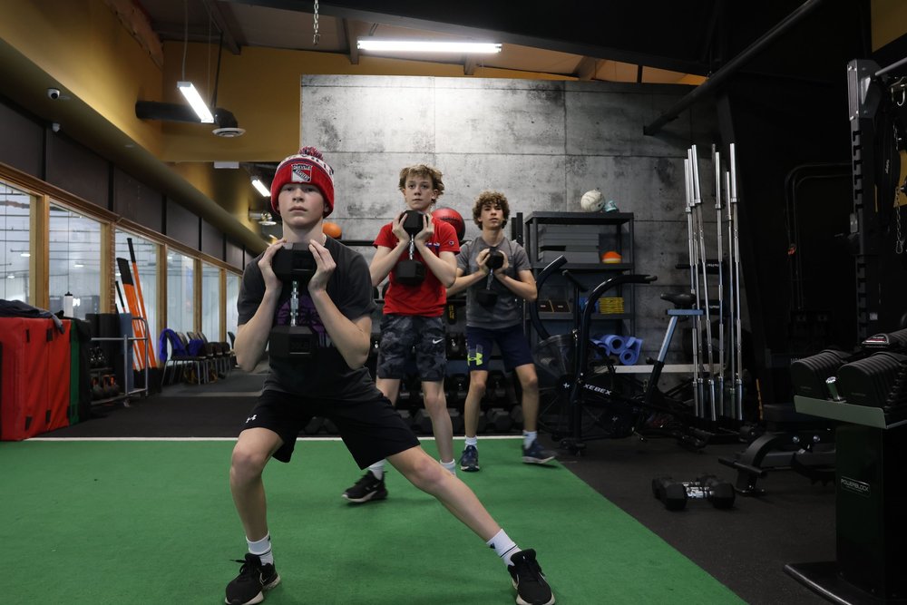 Young athletes lifting together at SHIELD