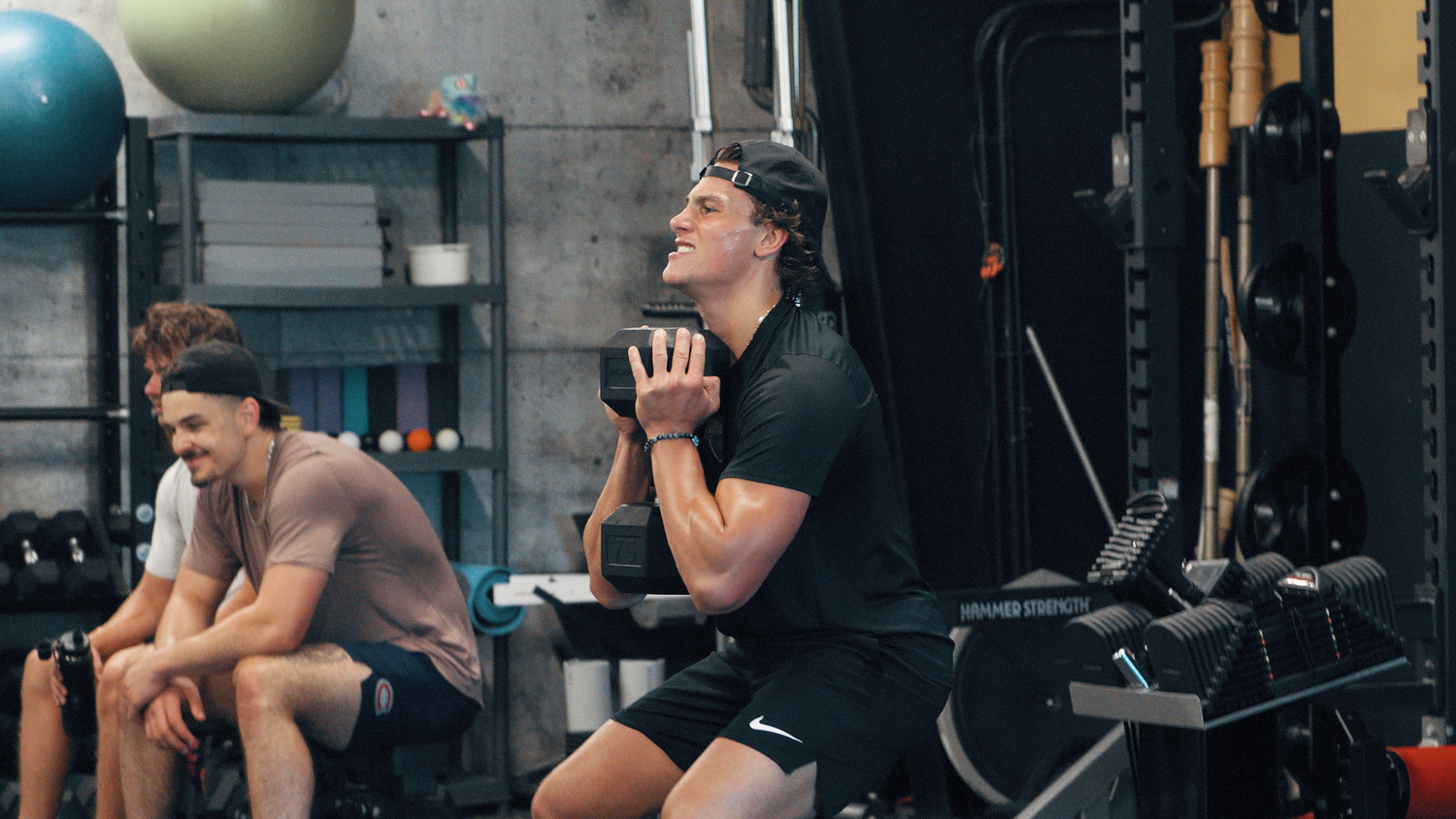 Athlete performing a dumbbell squat at SHIELD