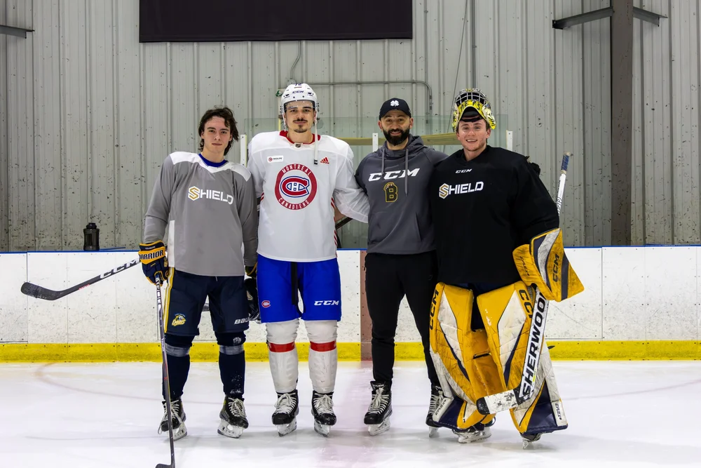 Professional hockey players training on the ice at SHIELD Athletics