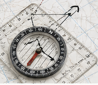A compass placed on a map with a ruler and protractor for navigation and measurements.