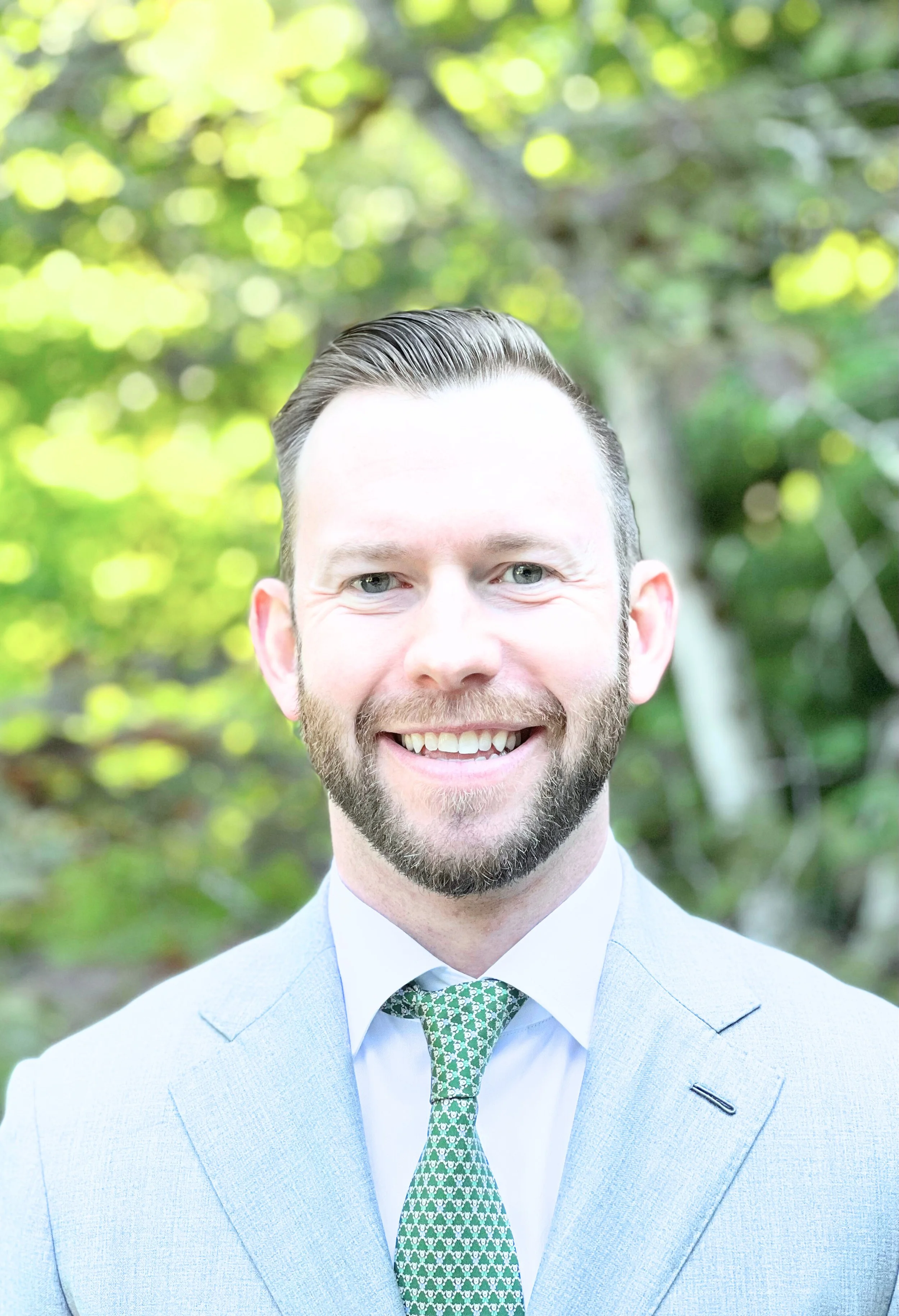 image of a white male wearing a suit and outside in the sun