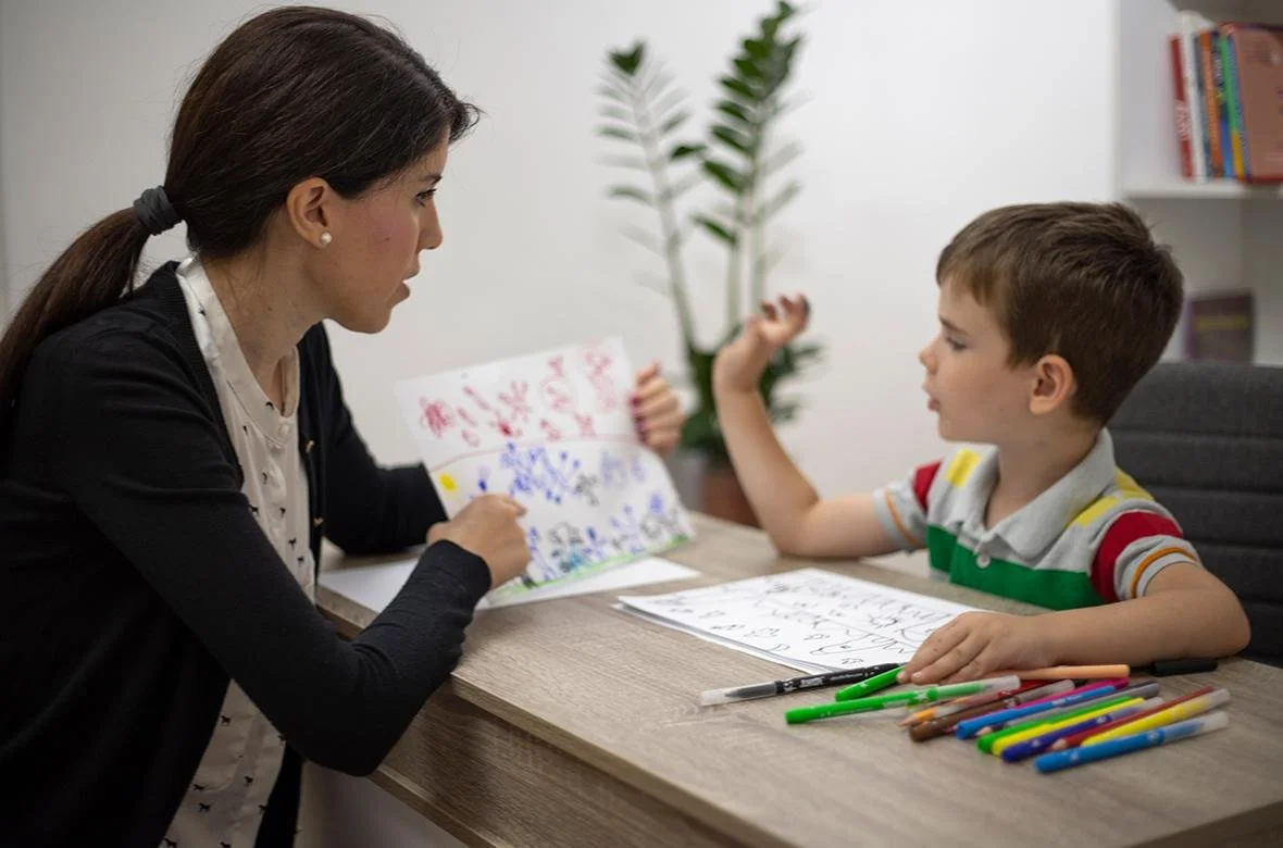 Child therapist using play-based activities to help a young client develop healthy coping skills during counseling.