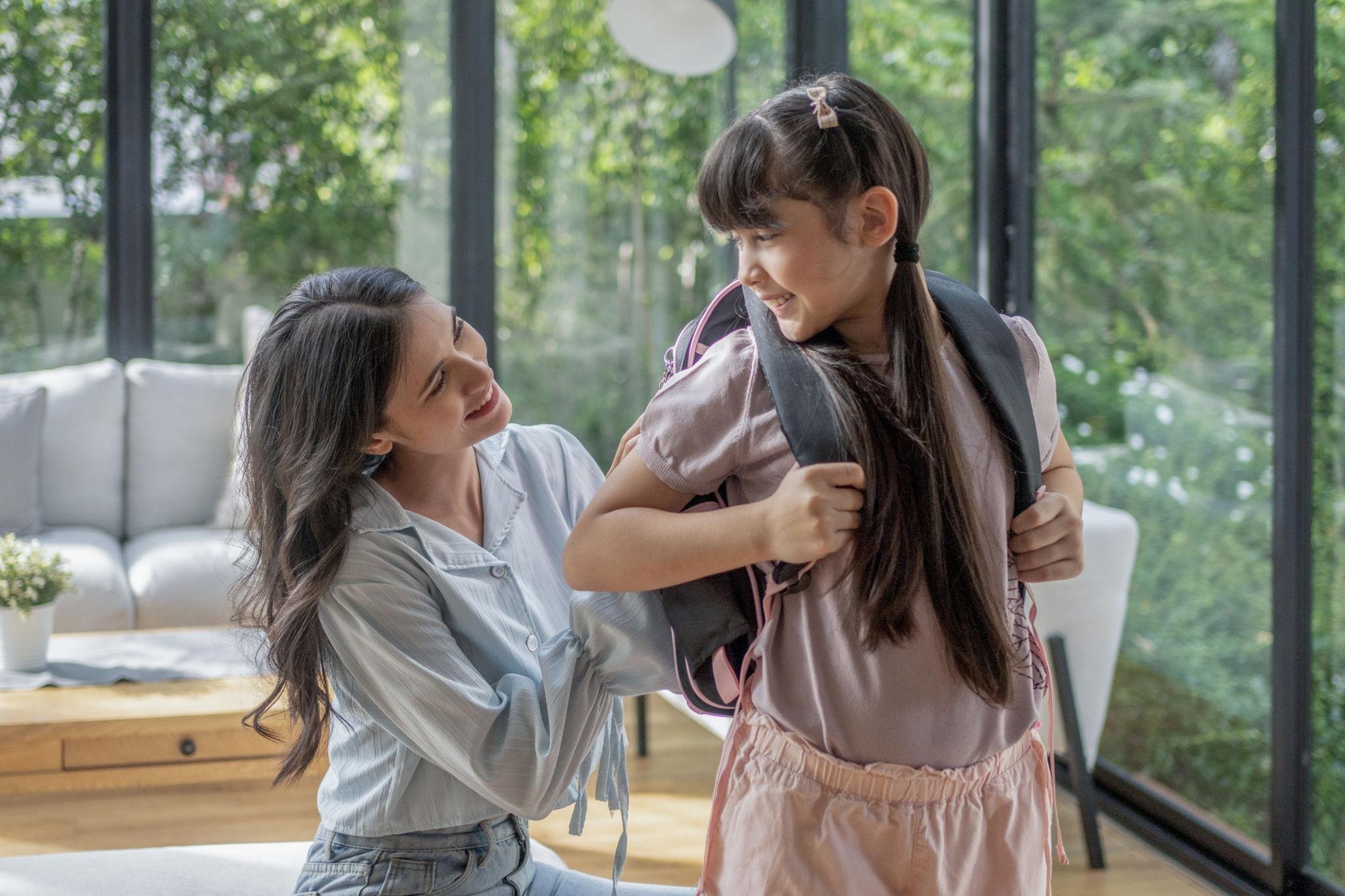 Parent encouraging their child before school to promote confidence, resilience, and mental health wellness.