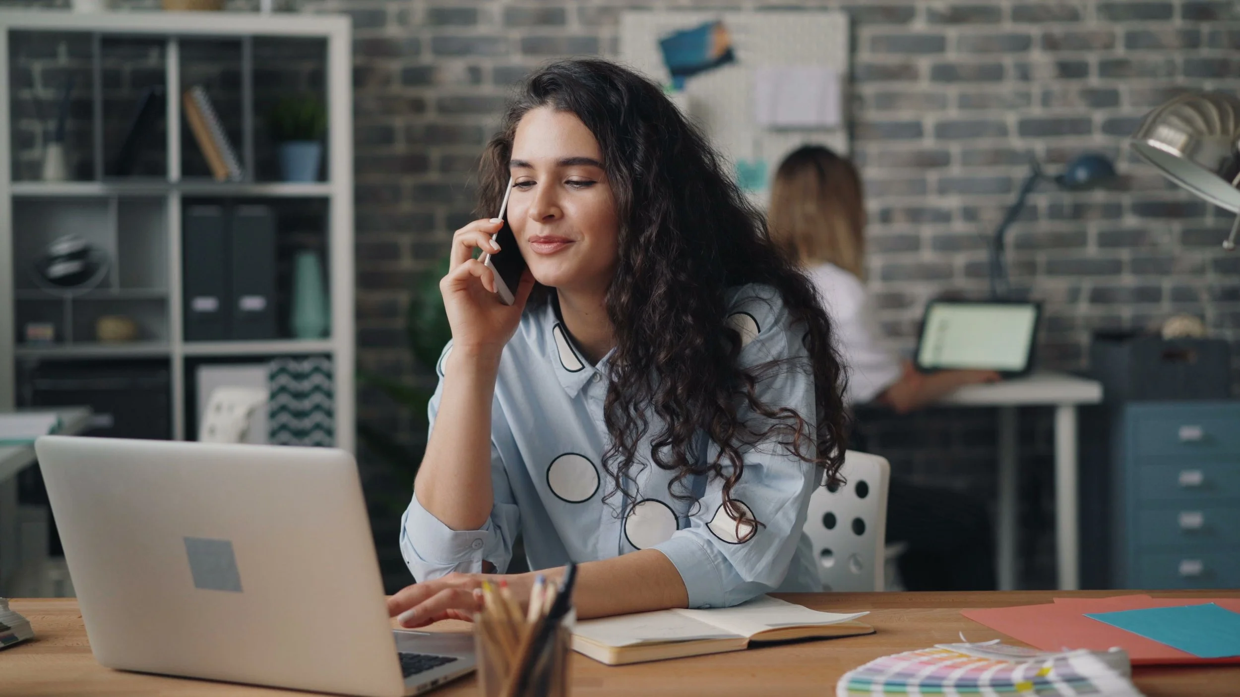Woman using a laptop while calling her insurance provider about therapy coverage in Arizona