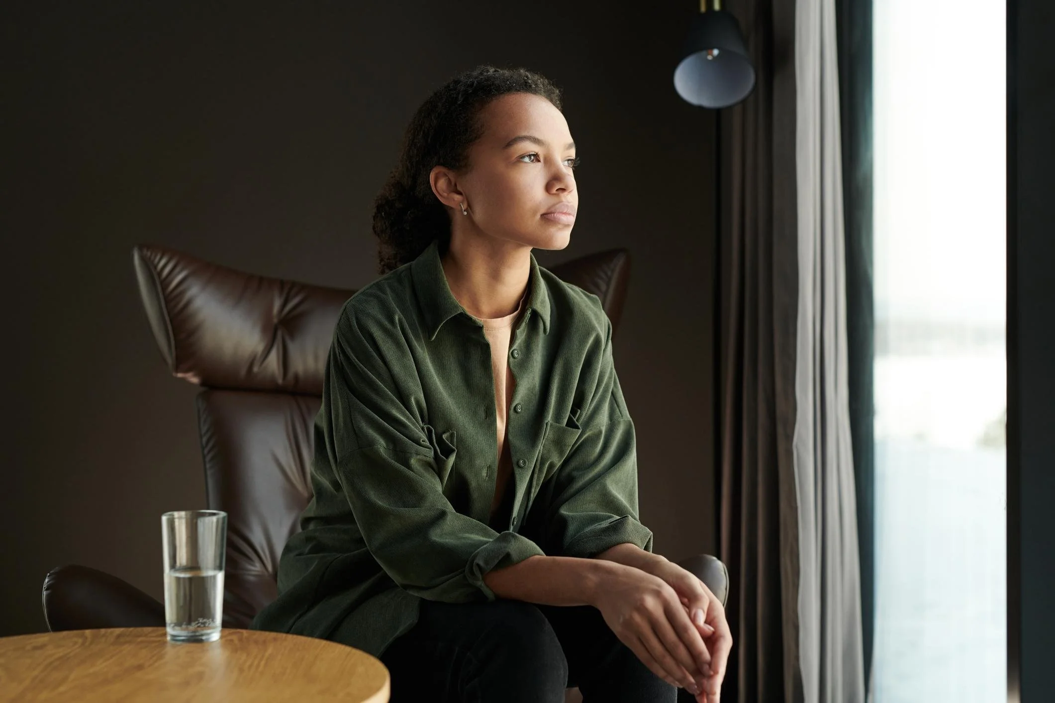 Woman sitting by a window reflecting on emotions and seeking mental health counseling for borderline personality disorder in Arizona