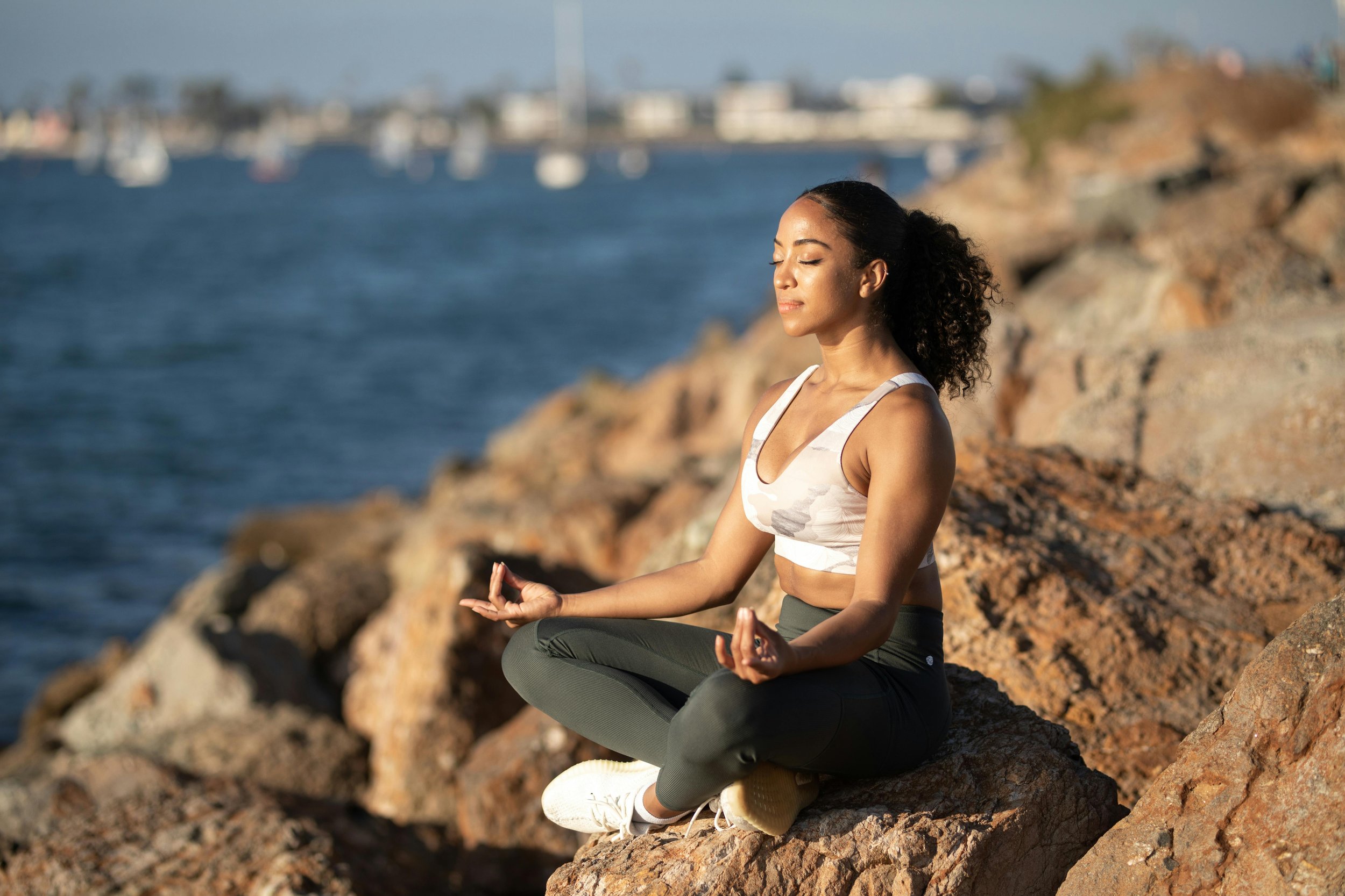Person meditating or doing deep breathing outdoors.