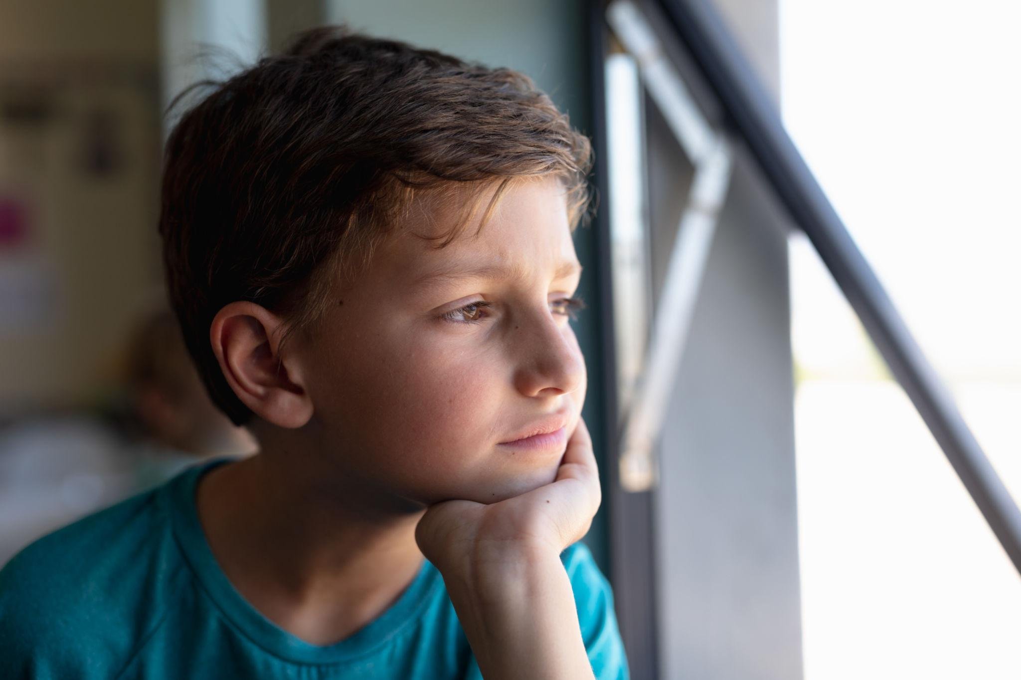 Young child thoughtfully reflecting while learning healthy ways to manage fears through child counseling in Arizona.