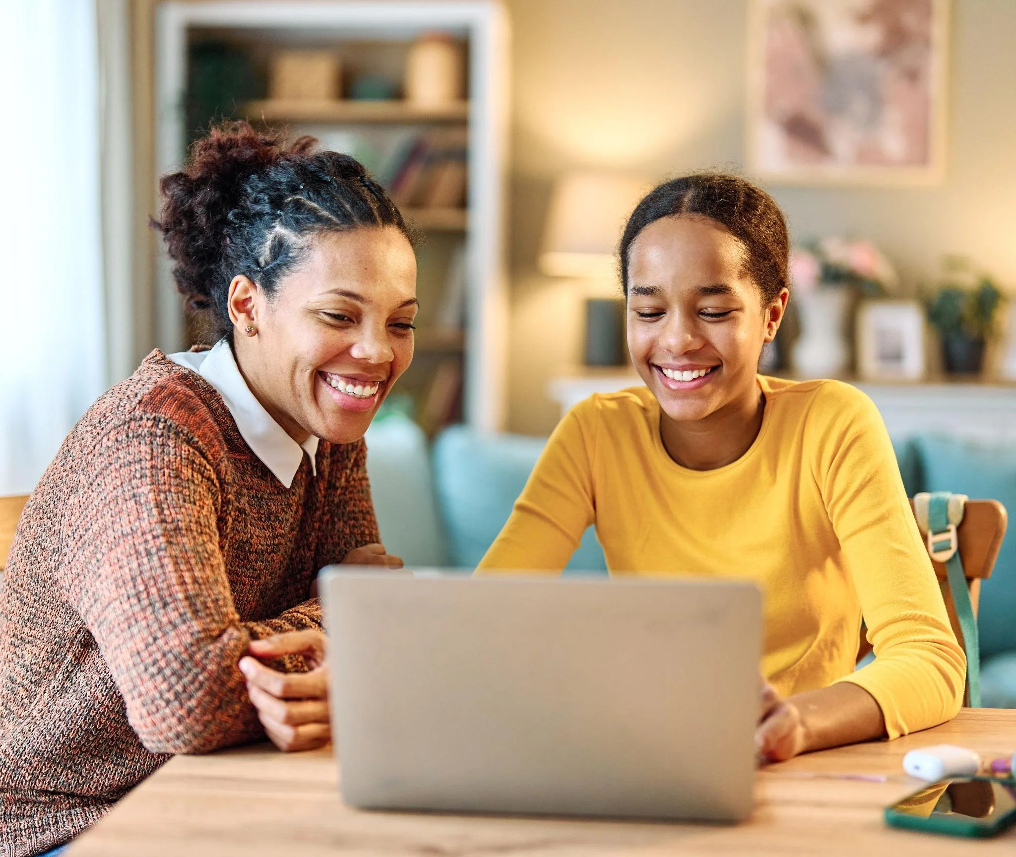 Parent helping a teenager with homework while building confidence and emotional well-being.
