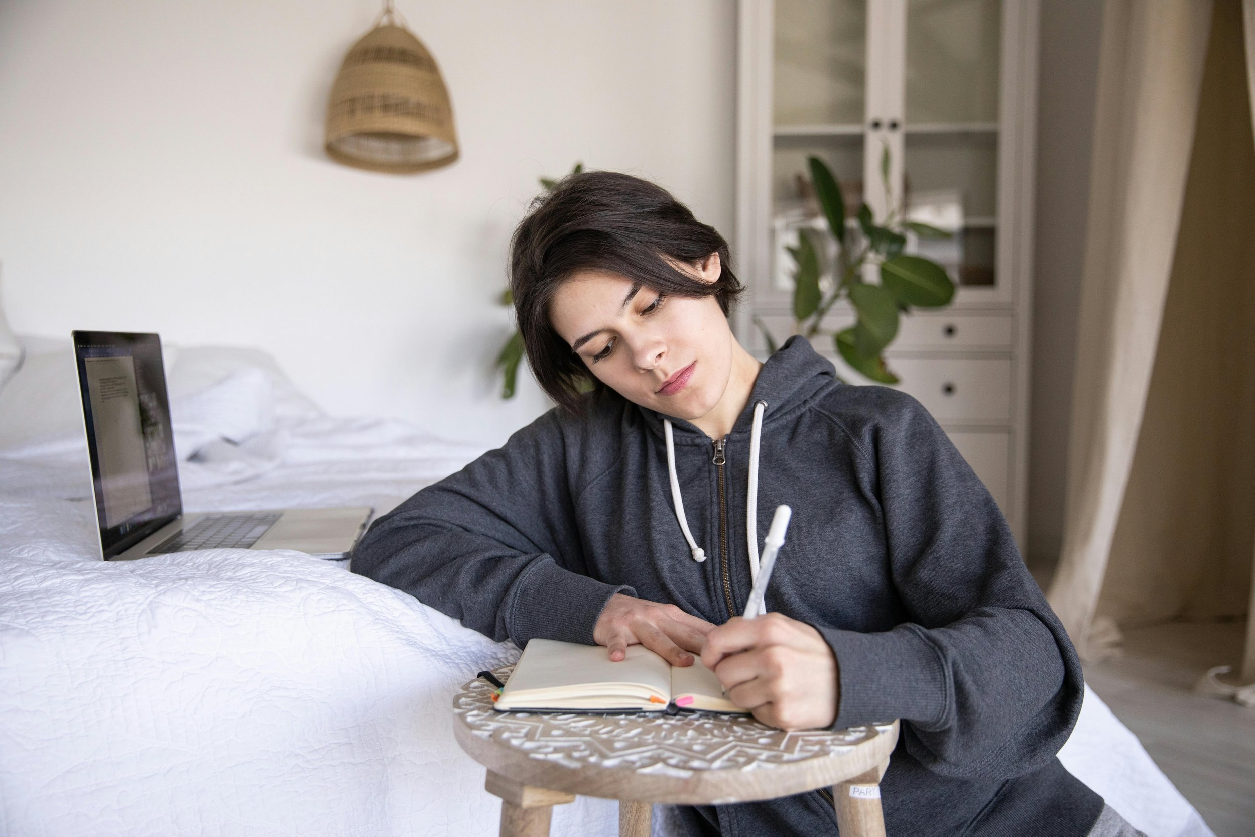 Person journaling on a bed