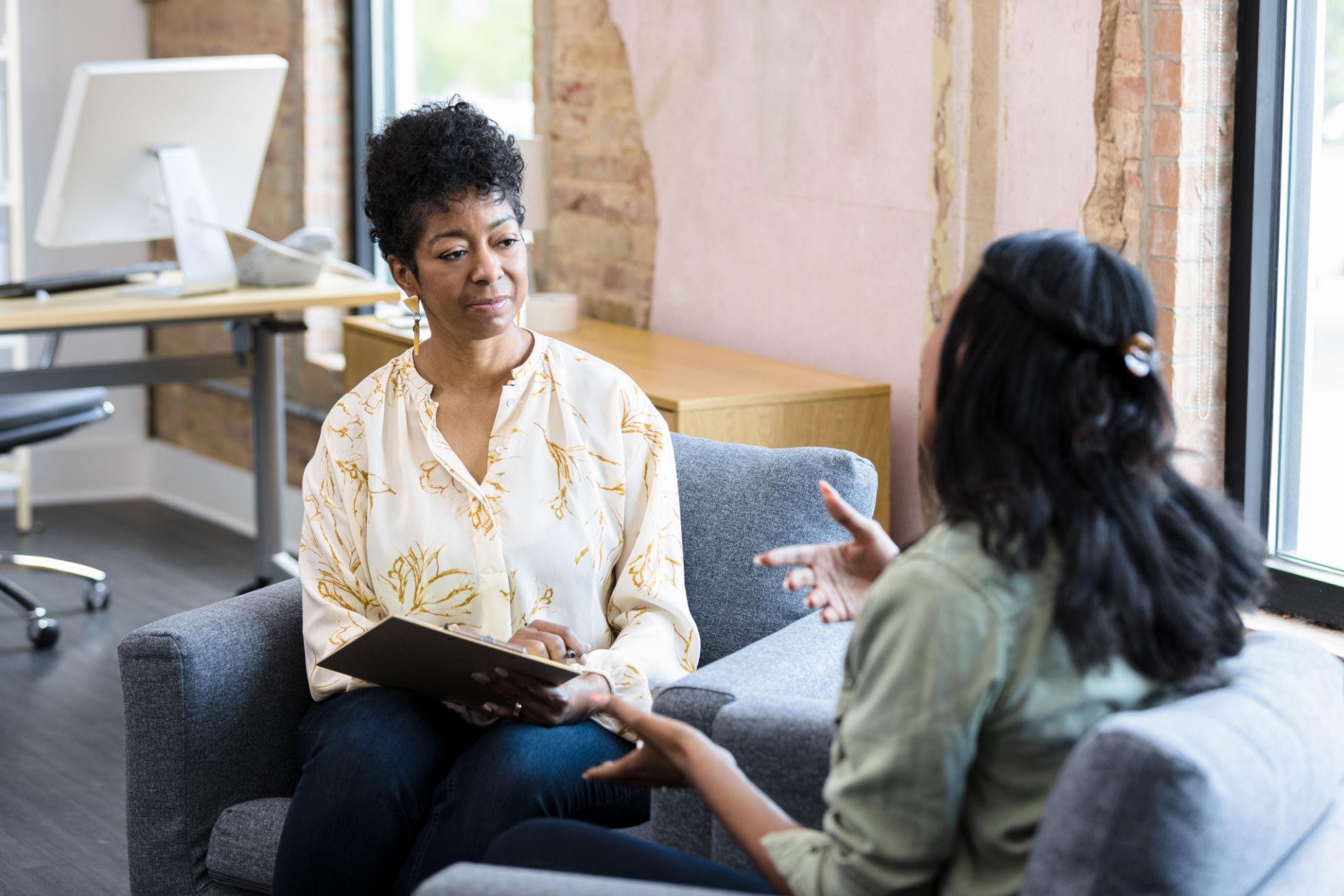 Therapist listening compassionately during an adult counseling session.
