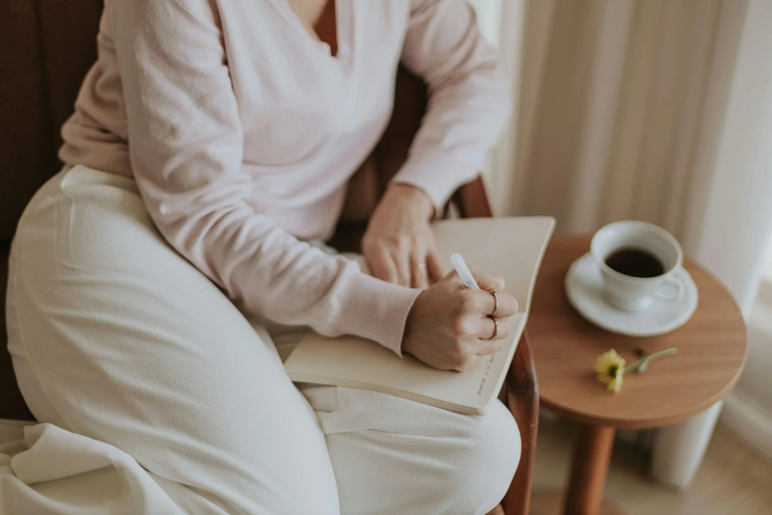 Woman journaling during a quiet moment of mental health wellness and self-reflection