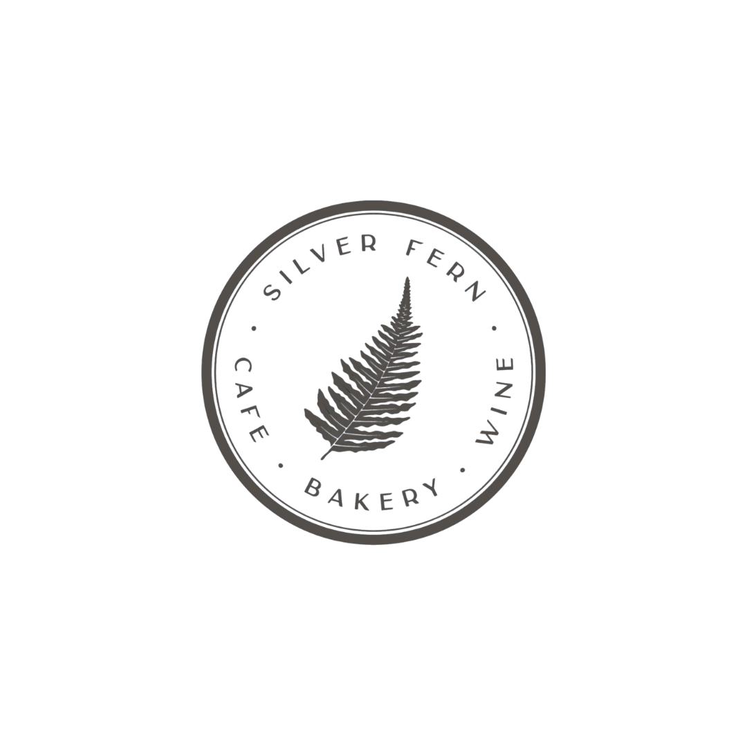 Logo featuring a fern leaf with the words 'Silver Fern' and the categories 'Cafe, Bakery, Wine' surrounding the leaf in a circular design.