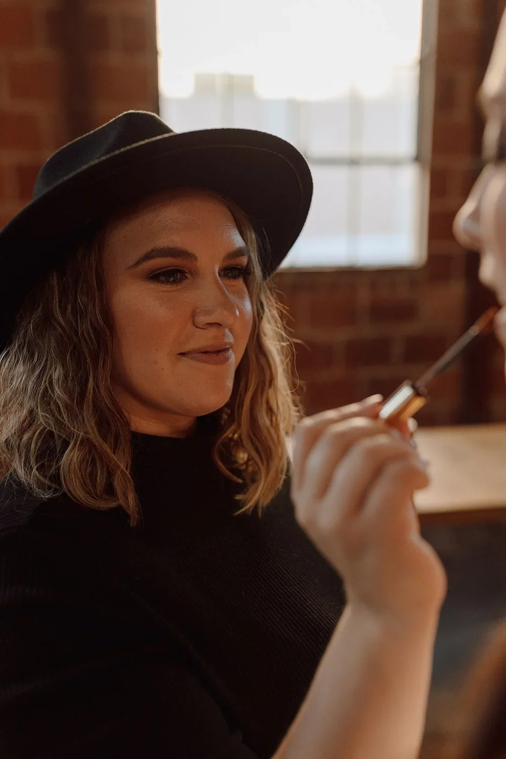 San Luis Obispo based wedding makeup artist (Kelly Mendoza) applies bridal makeup at The Penny SLO