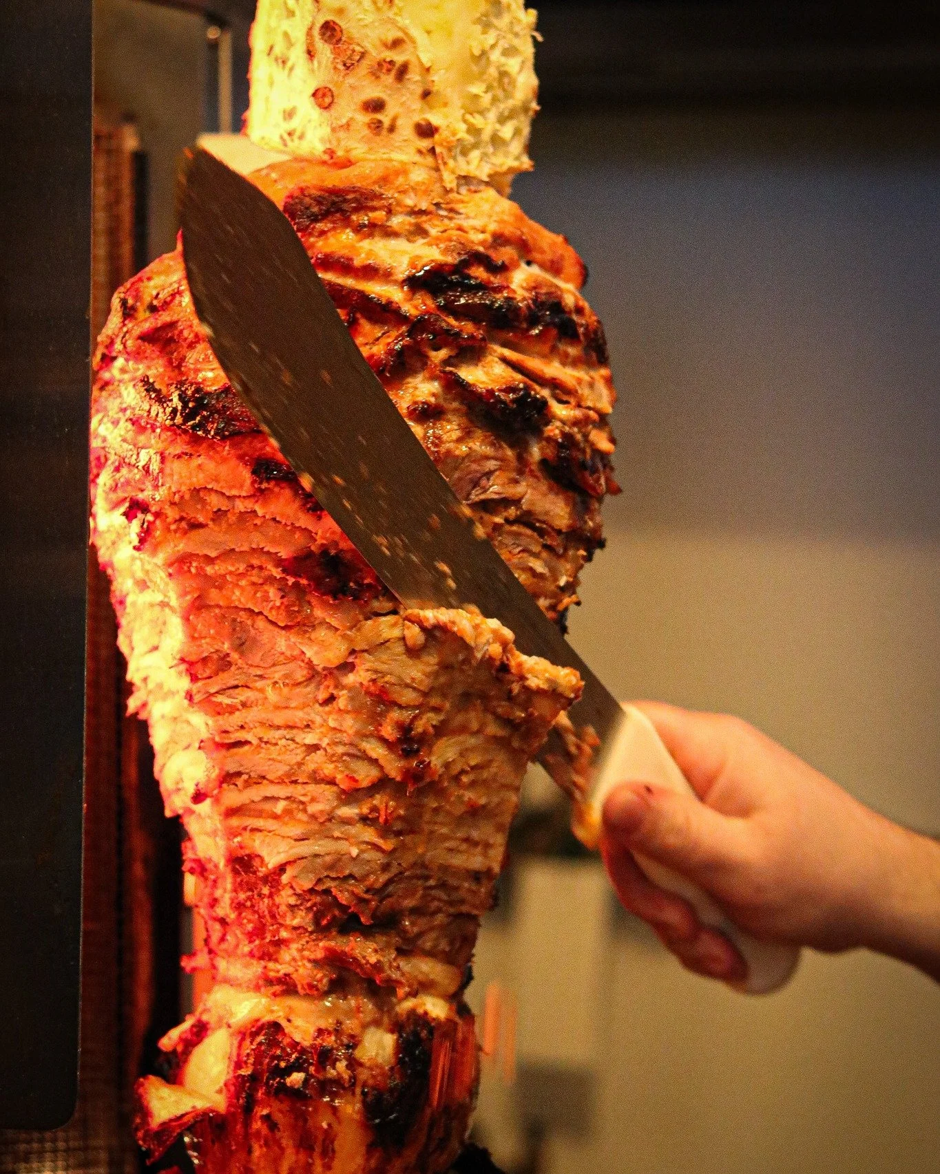 A real trompo takes hours to build and even longer to master.
Layer after layer of pork, marinated overnight in achiote, guajillo, and a house adobo we don't share the recipe for.
Stacked tall, capped with pineapple, slow-turned until the edges crisp