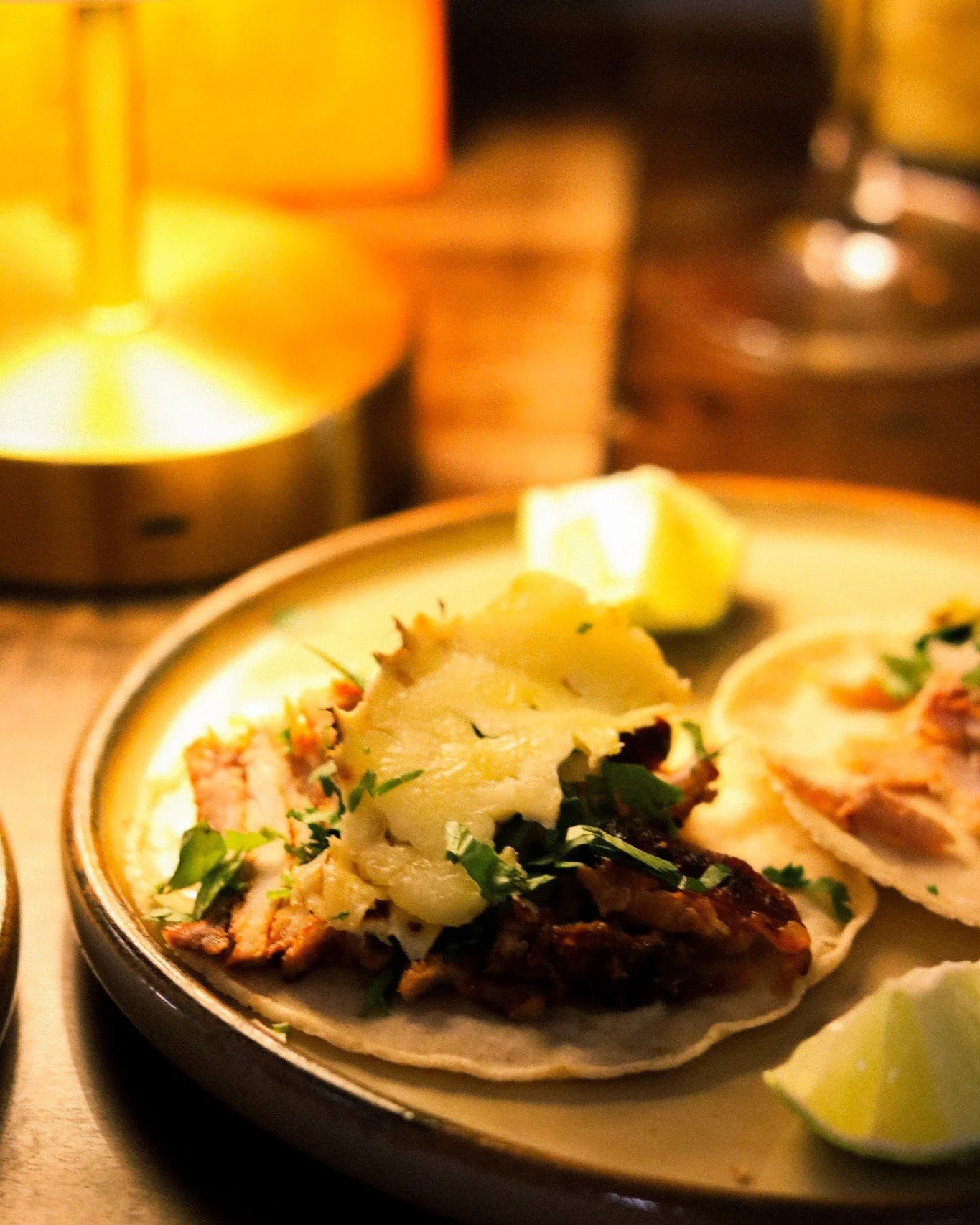 The taco al pastor &mdash; Mexico City on a tortilla.
Marinated pork in adobo, crowned with that signature char and a slice of grilled pi&ntilde;a, finished with onion and cilantro.
Born from Lebanese shawarma, reborn on the streets of la capital, pe