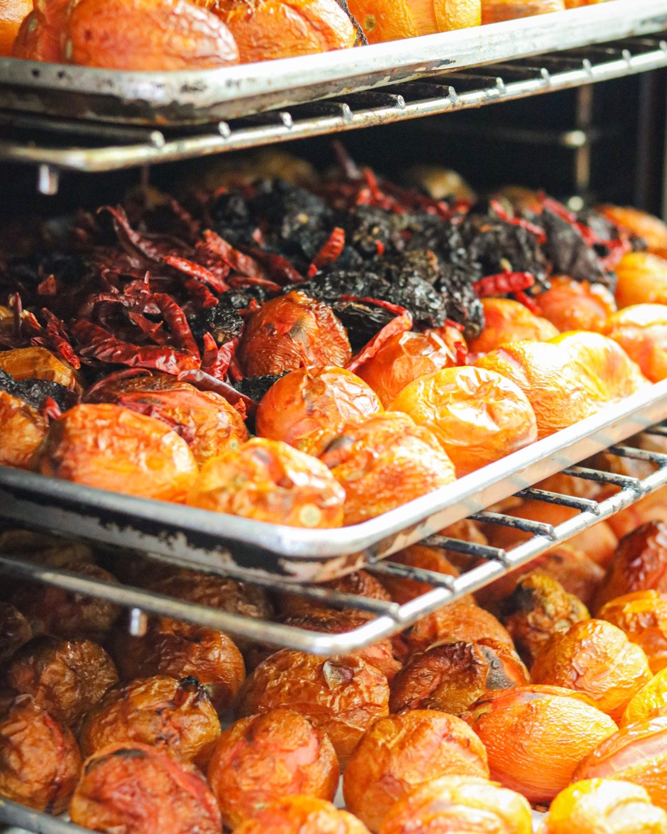This is where flavour begins. 🔥
Trays of fire-roasted tomatoes, onions, and dried chiles &mdash; charred slowly to bring out the deep, smoky sweetness that defines real Mexican salsas.
No shortcuts, no canned bases. Just whole ingredients, roasted i