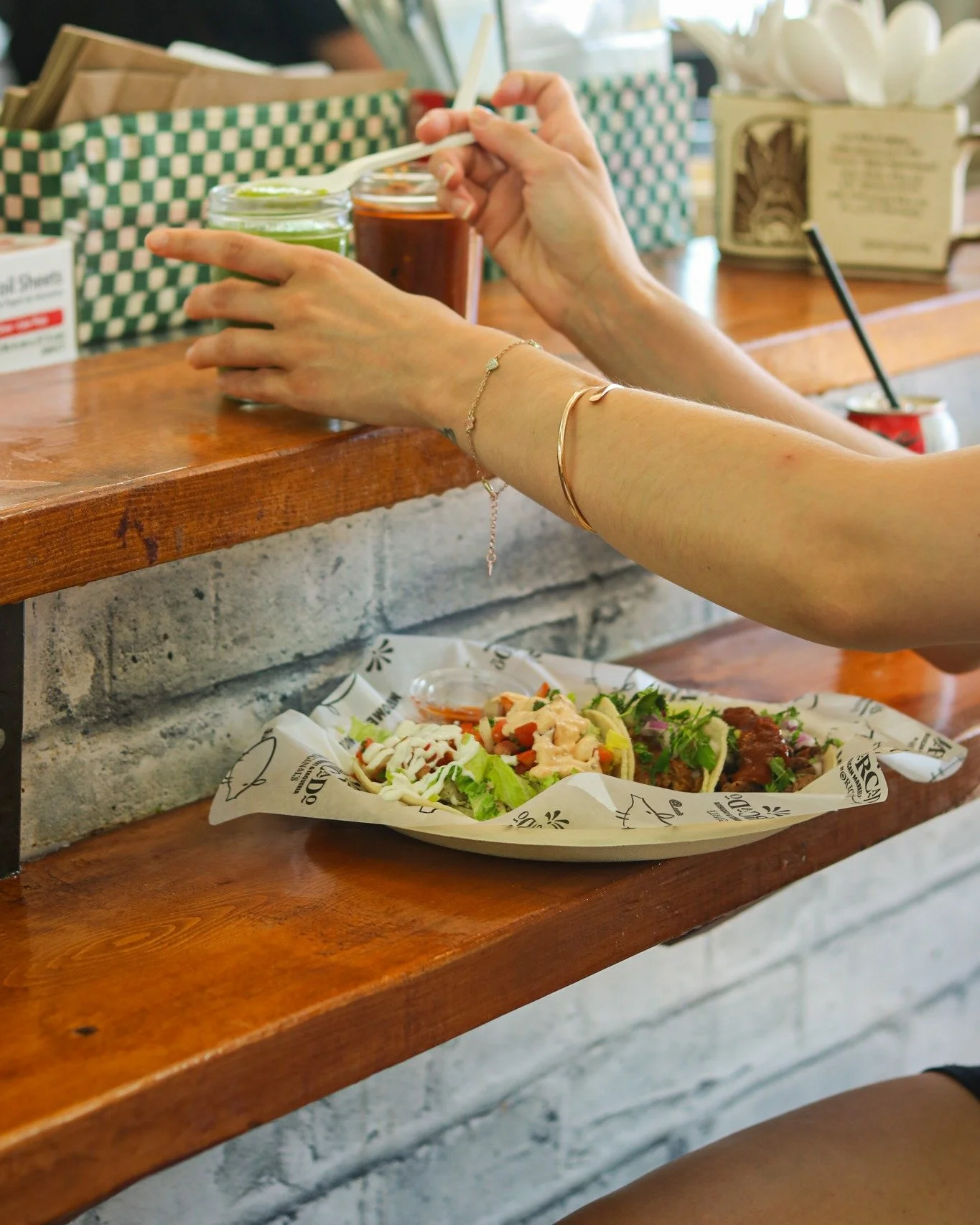This is the mercado experience. 🌮✨
Salsas in hand, tacos on deck, good company all around.
In Mexican culture, food has always been about gathering &mdash; at the market, at the counter, at the table.
You don't just eat at Mercado. You settle in. P&