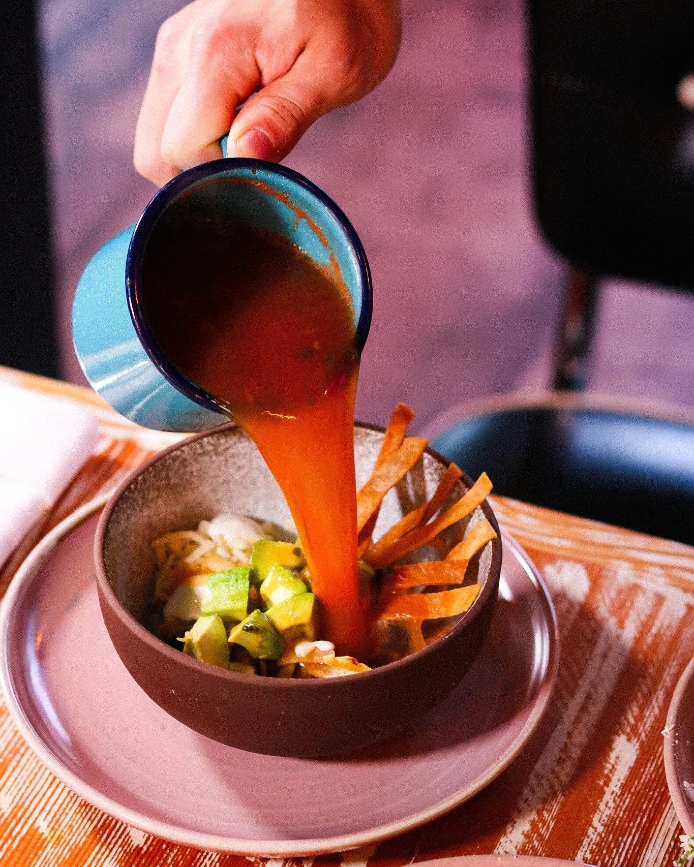 The pour that changes everything. 🍲✨
Our Sopa Azteca Guerrera is built tableside &mdash; fresh avocado, cheese, crema, and hand-cut tortilla strips wait in the bowl while the rich tomato-chipotle broth comes pouring in hot.
This isn't a soup that ge
