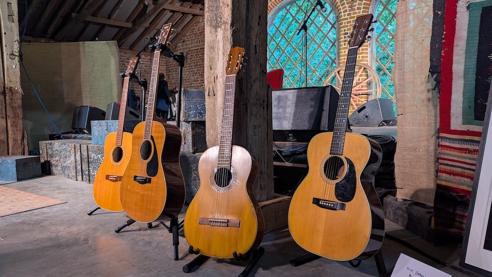 Legendary guitars on the Second Cousins Stage at FolkEast, 2025. L-R: Andy Matheou’s Yamaha (as used by John Martyn on his ‘Bless the Weather’ album), Bert Jansch’s Yamaha, Sandy Denny’s guitar (I’m unsure of the make), Nick Drake’s Martin 000-28.
